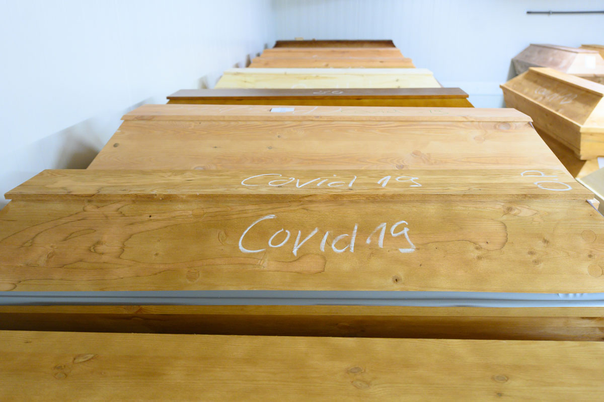 "Covid-19" is written in chalk on a coffin containing a person who died of or with the coronavirus at the Dresden-Tolkewitz crematorium in Saxony, Germany on December 29.