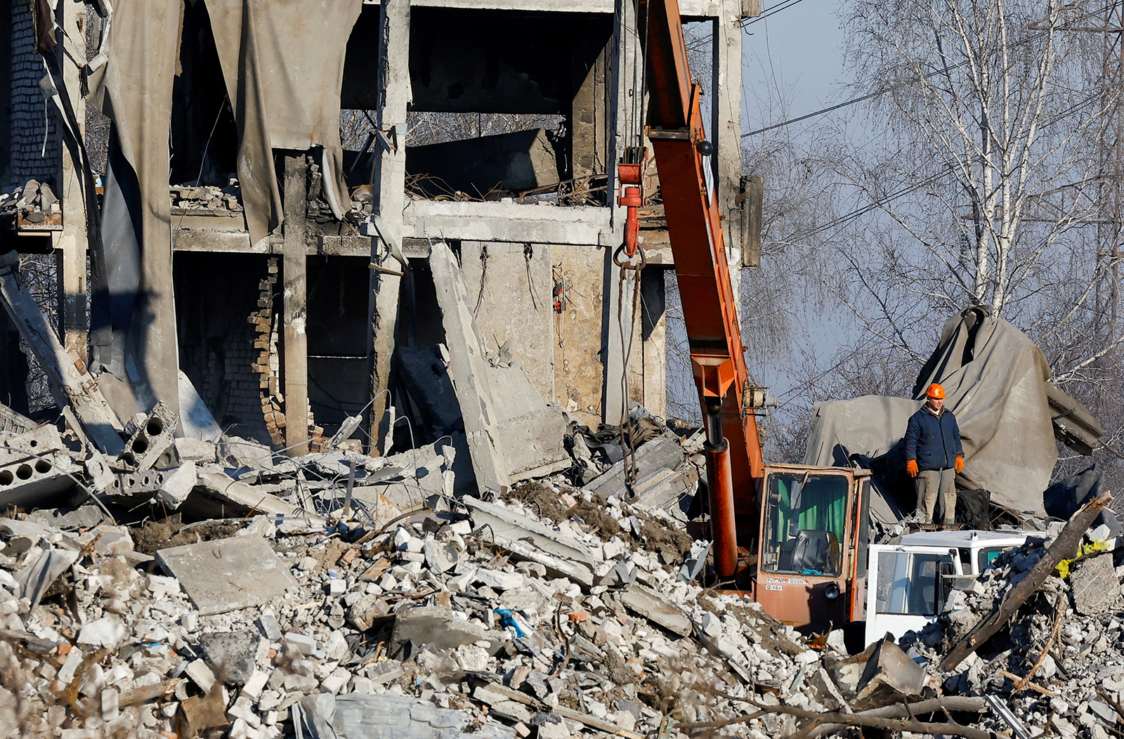 Workers remove debris of a destroyed building in Makiivka on January 3.