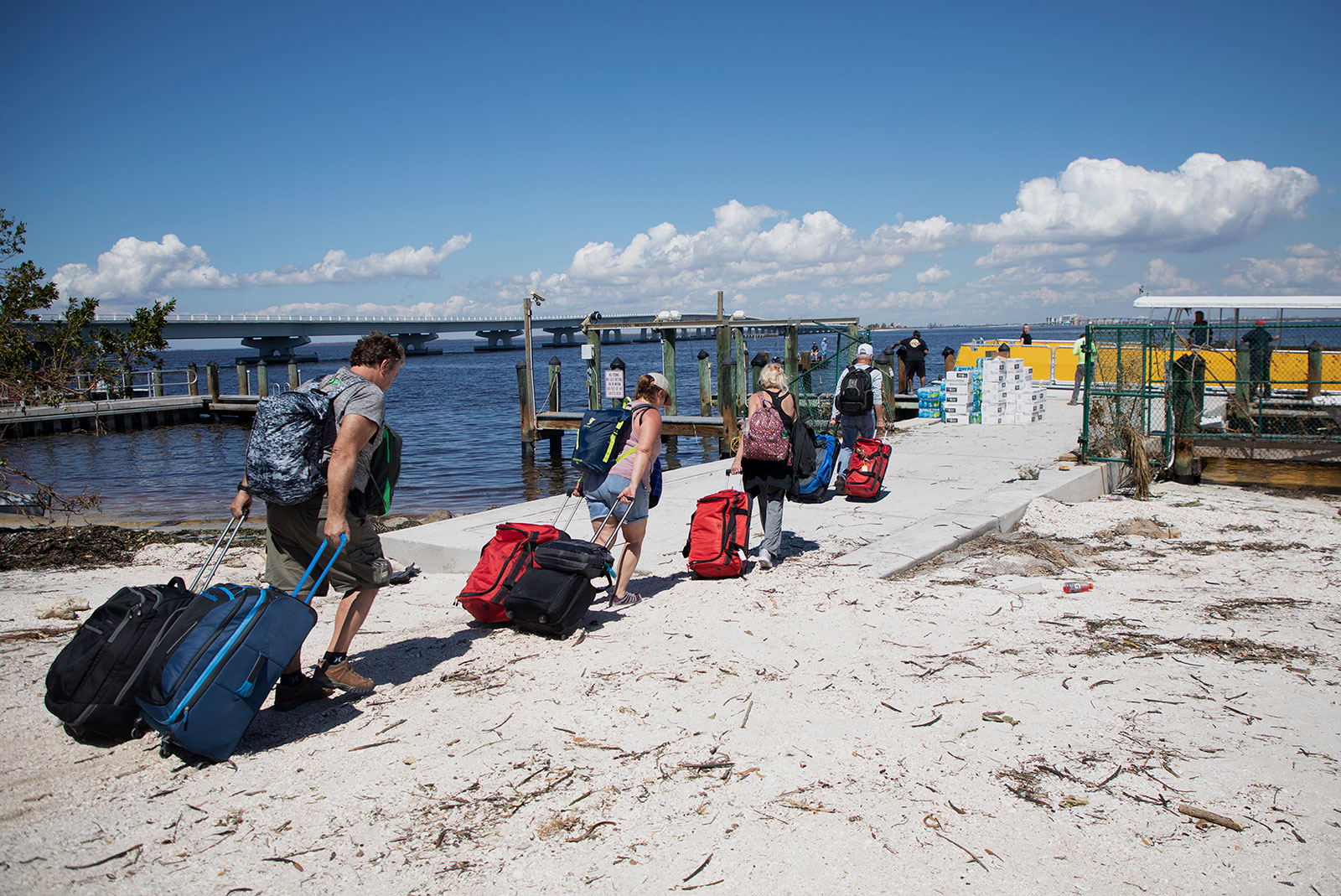 People walk toward a ferry boat to be evacuated from Sanibel Island on October 1. 