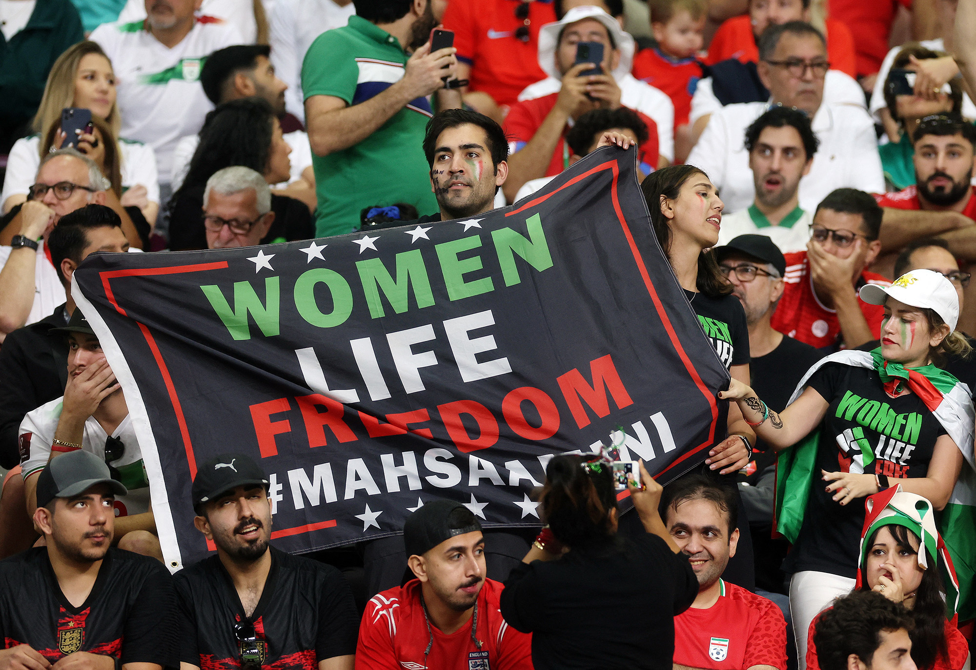 Iran fans hold a banner reading 'Woman life freedom' inside the stadium during the match vs England on November 21.