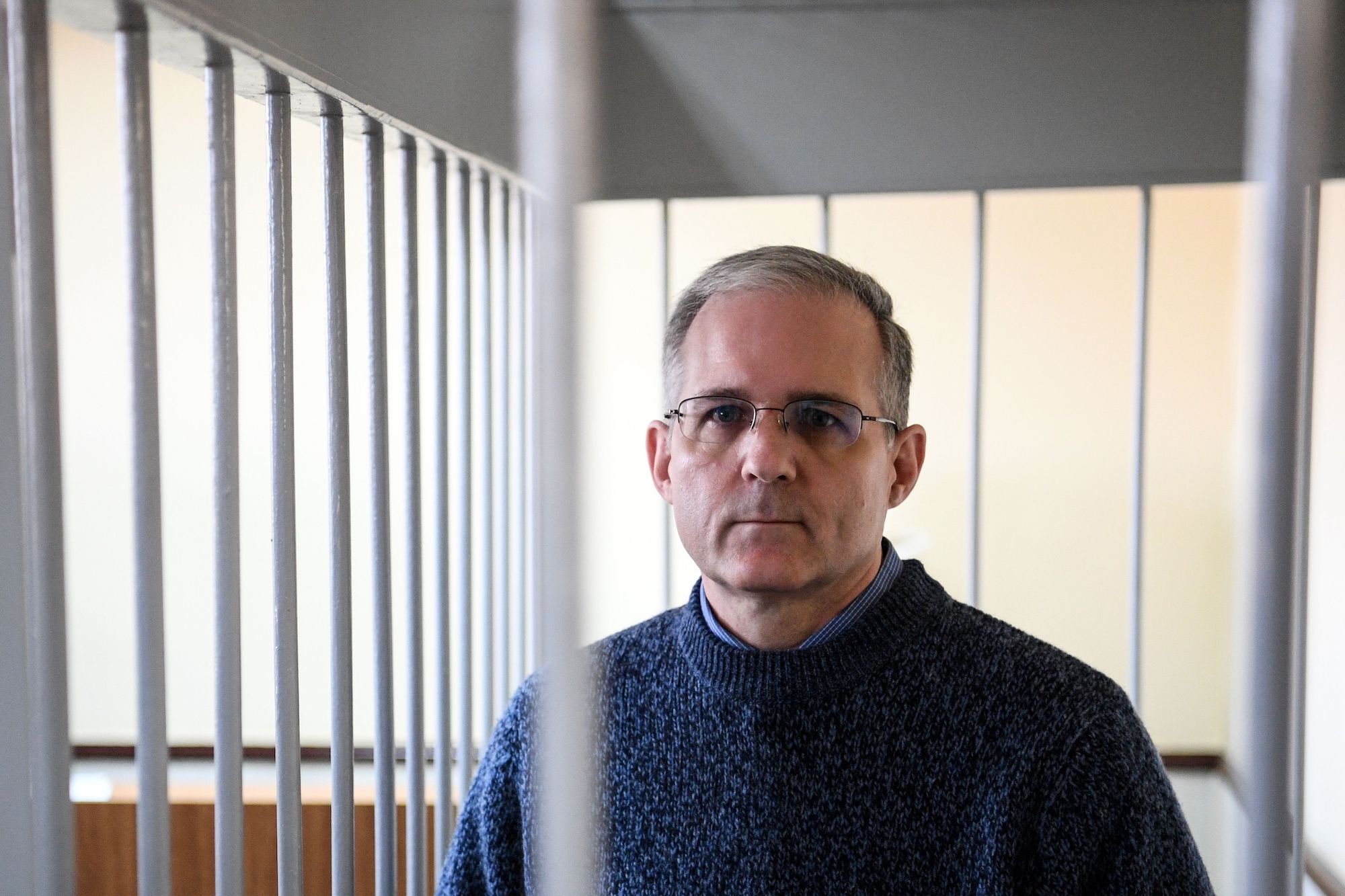 Paul Whelan stands inside a defendants' cage during a hearing at a court in Moscow on August 23, 2019.