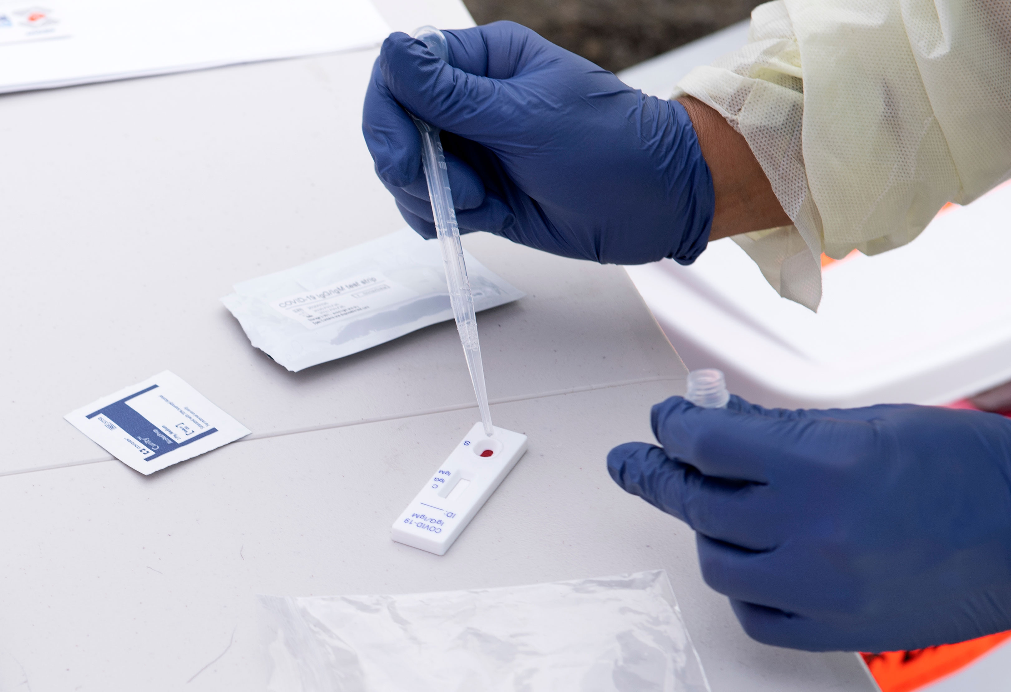 A health worker in Torrance, California, processes a Covid-19 antibody test in May 2020.