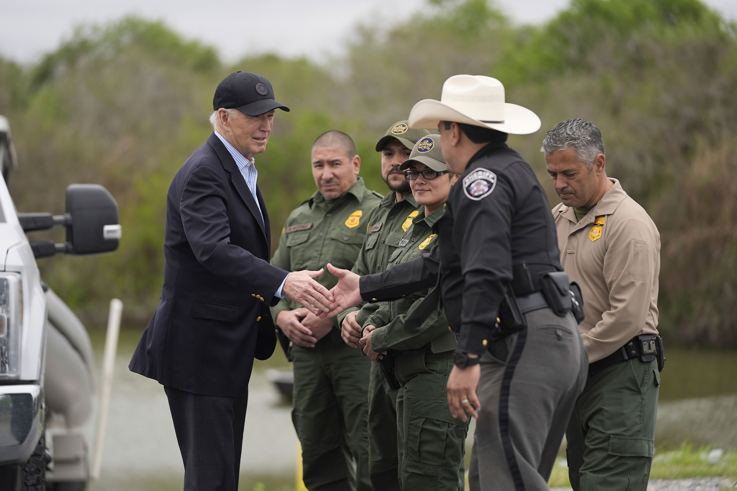 President Joe Biden talks with the US Border Patrol and local officials, as he looks over the southern border on Thursday. 