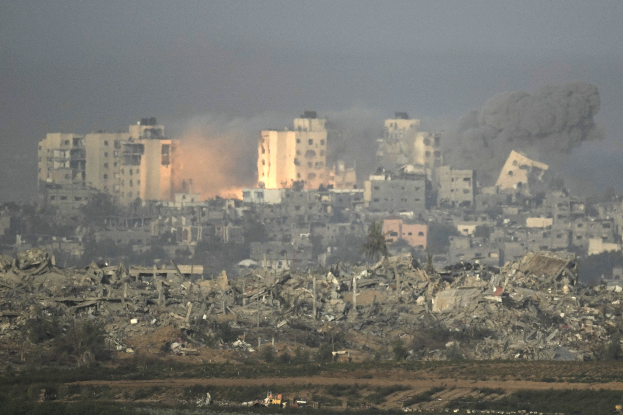An explosion is seen following an Israeli airstrike in Gaza, as seen from southern Israel, on November 23.