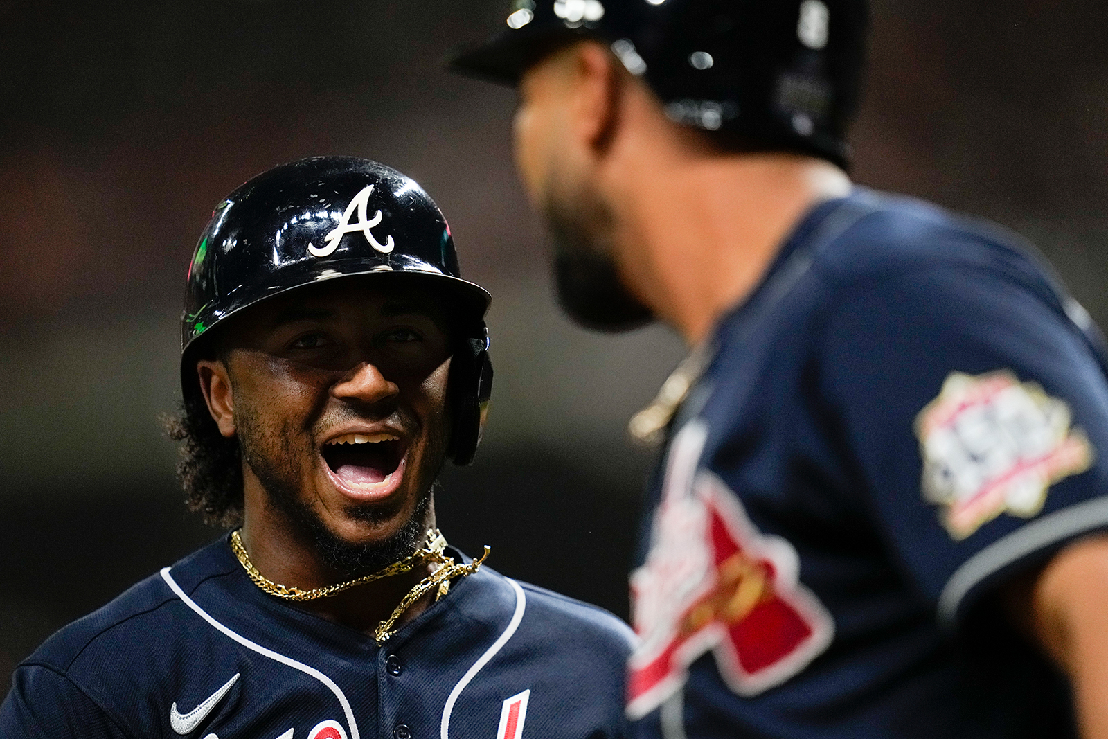 Atlanta Braves' Ozzie Albies celebrates after scoring on a double by Austin Riley during the first inning.