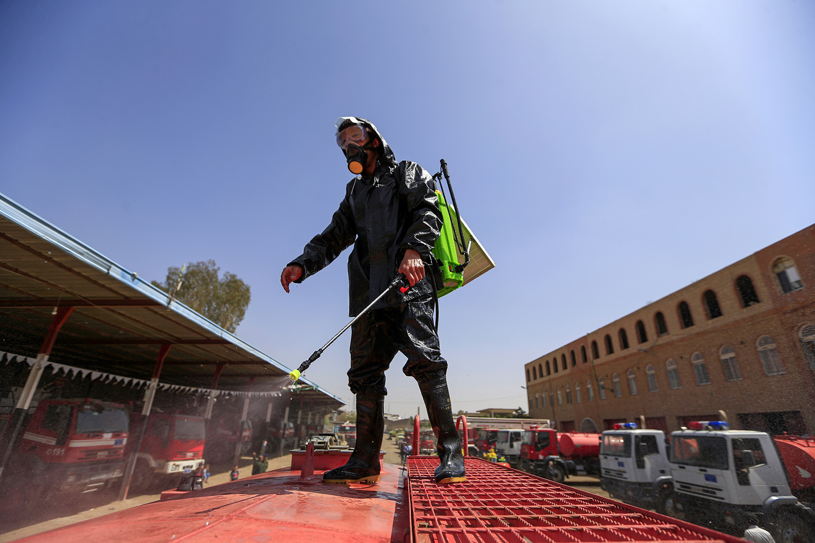 A member of the Yemeni Civil Defense sprays disinfectant on a tank truck in Sanaa, on Sunday, April 12.