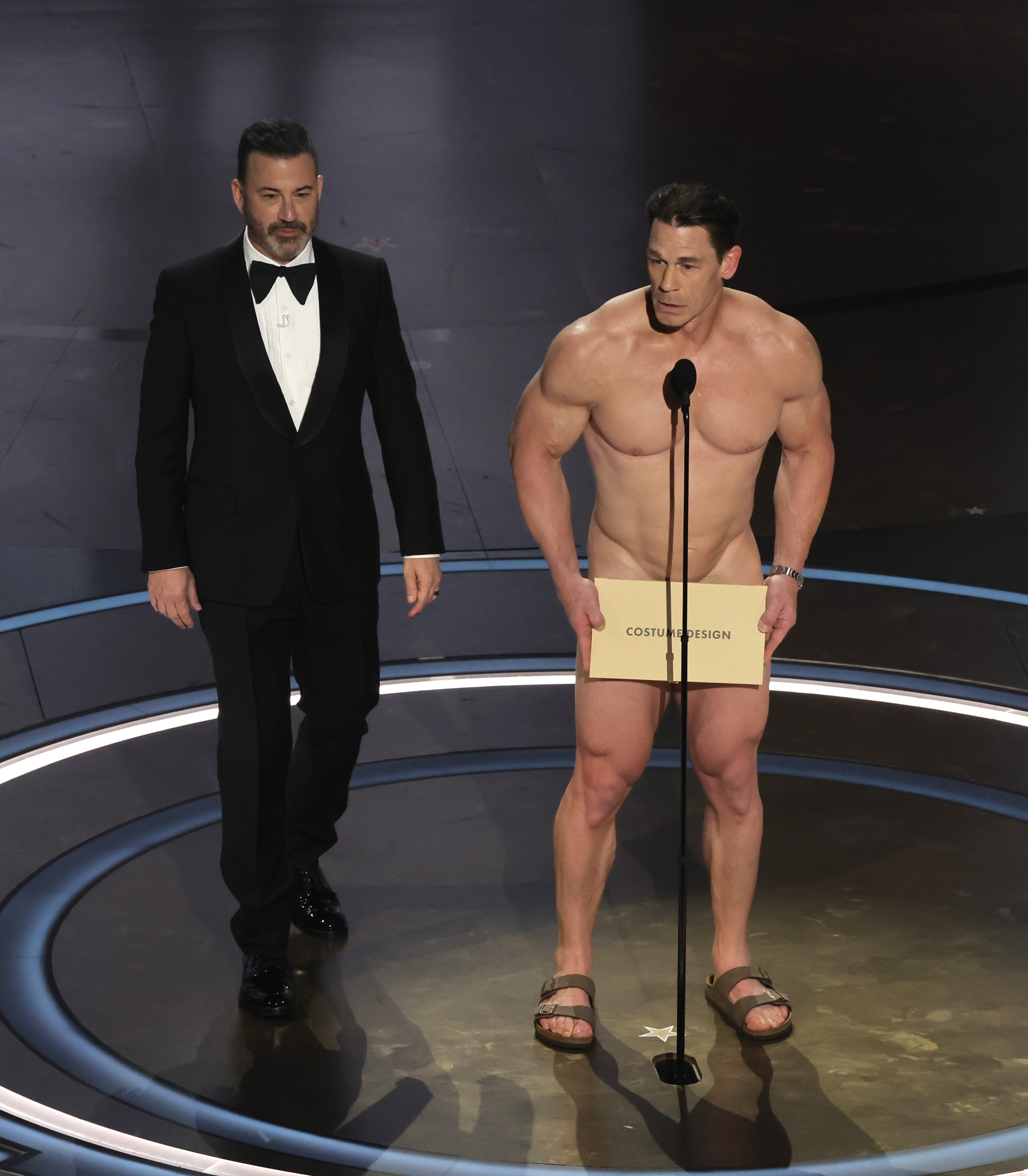 Jimmy Kimmel and John Cena speak onstage. 