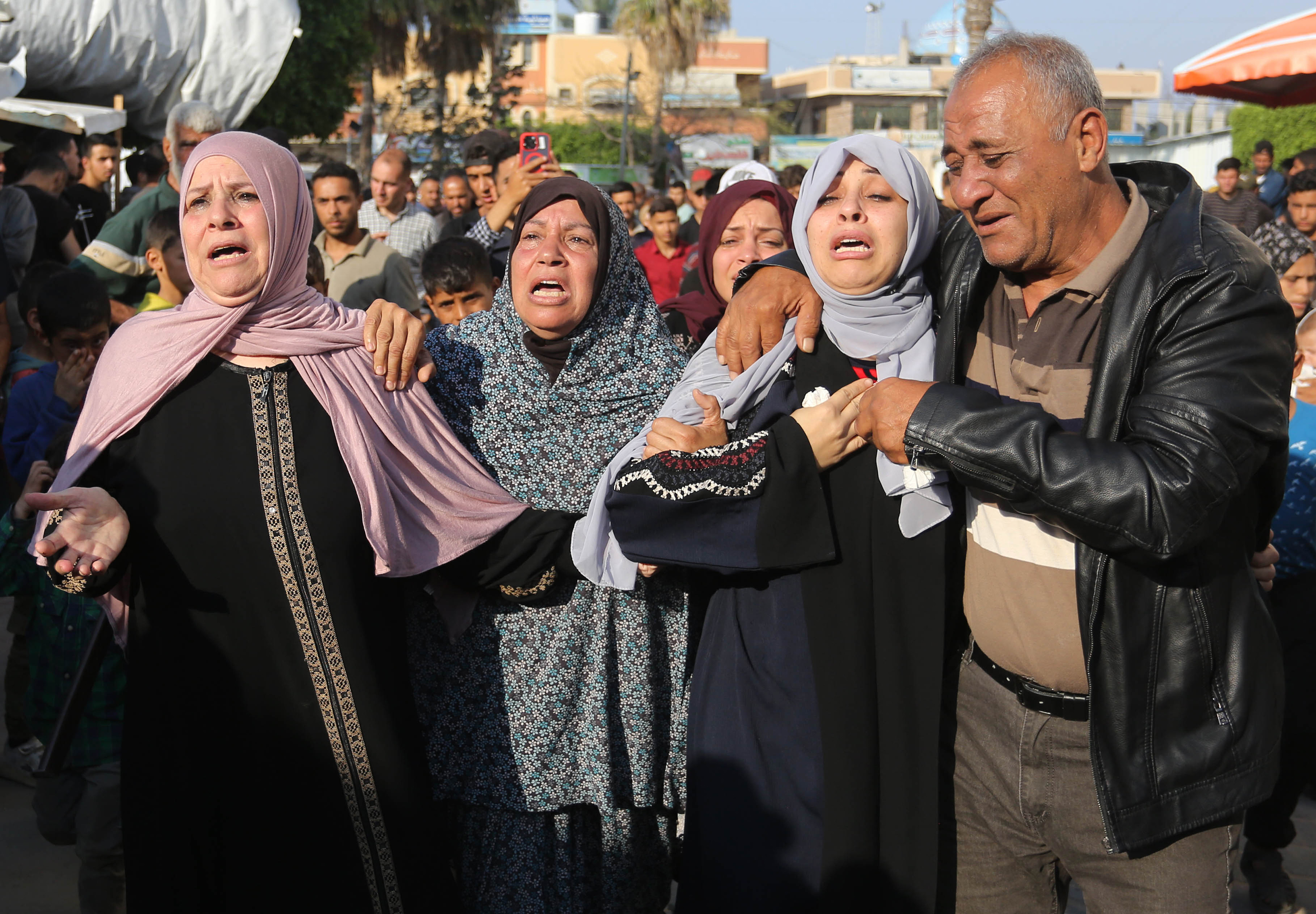 Relatives of the Palestinians who were killed in Israeli attacks at Al-Maghazi Refugee camp mourn in central Gaza on April 16.