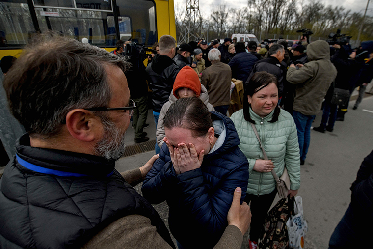 People fleeing fighting Mariupol meet with relatives and friends as at a registration center for internally displaced people in Zaporizhzhia on Thursday, April 21.