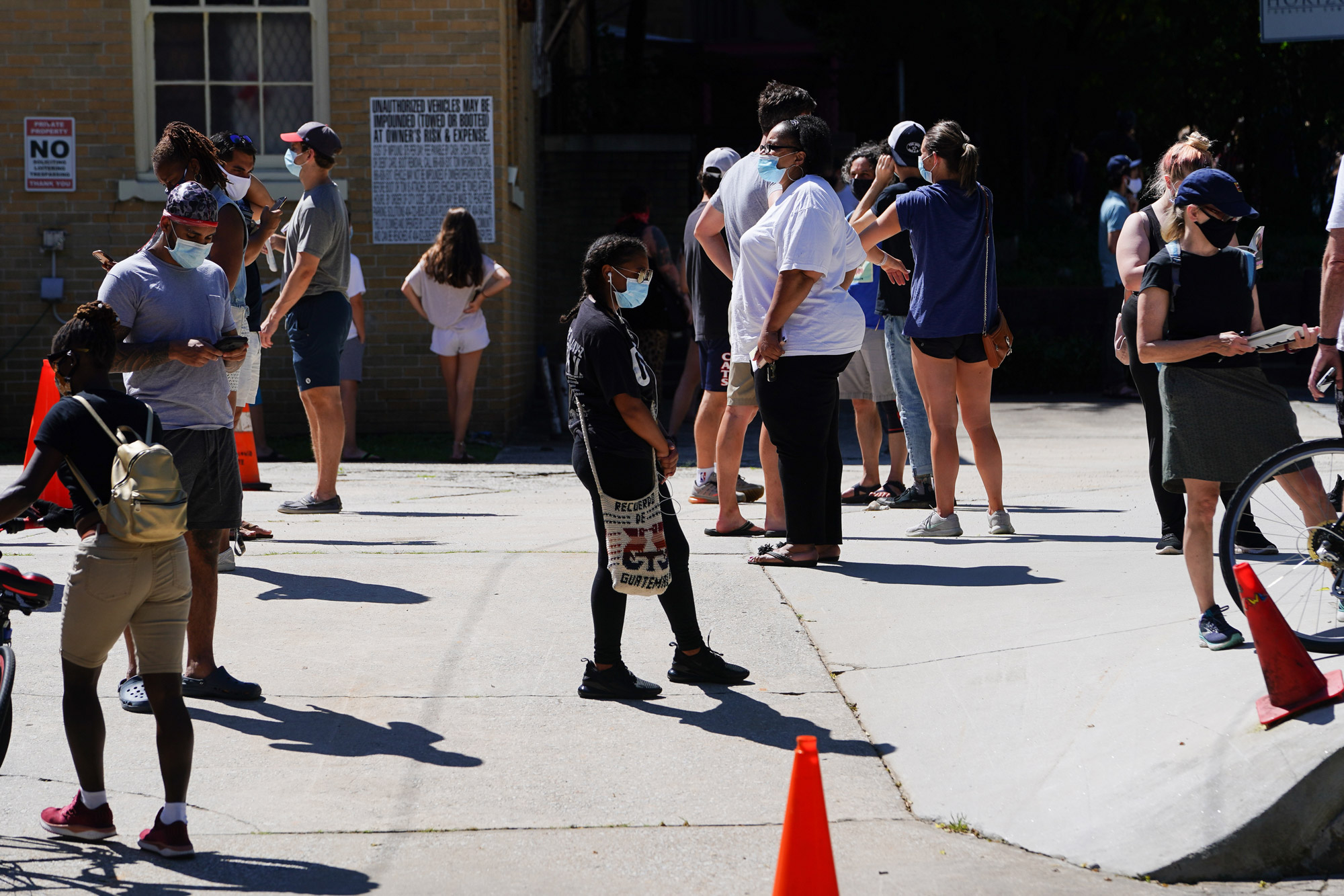 People stand in line to get tested for COVID-19 at a free walk-up testing site on July 11 in Atlanta.