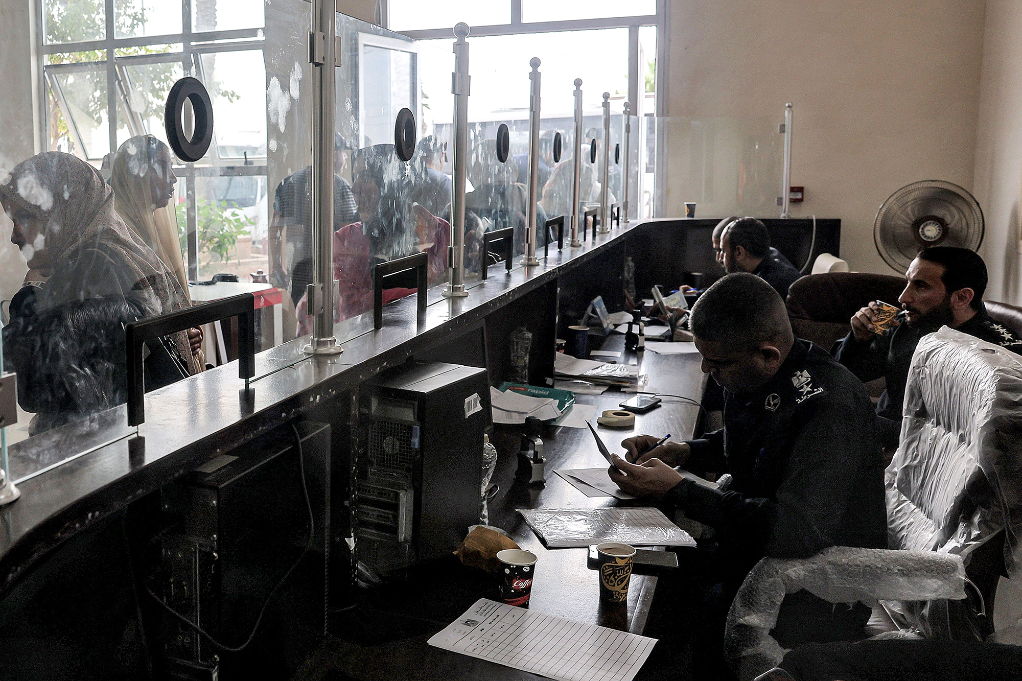 People present their travel documents at the Rafah border crossing in Gaza on November 12. 