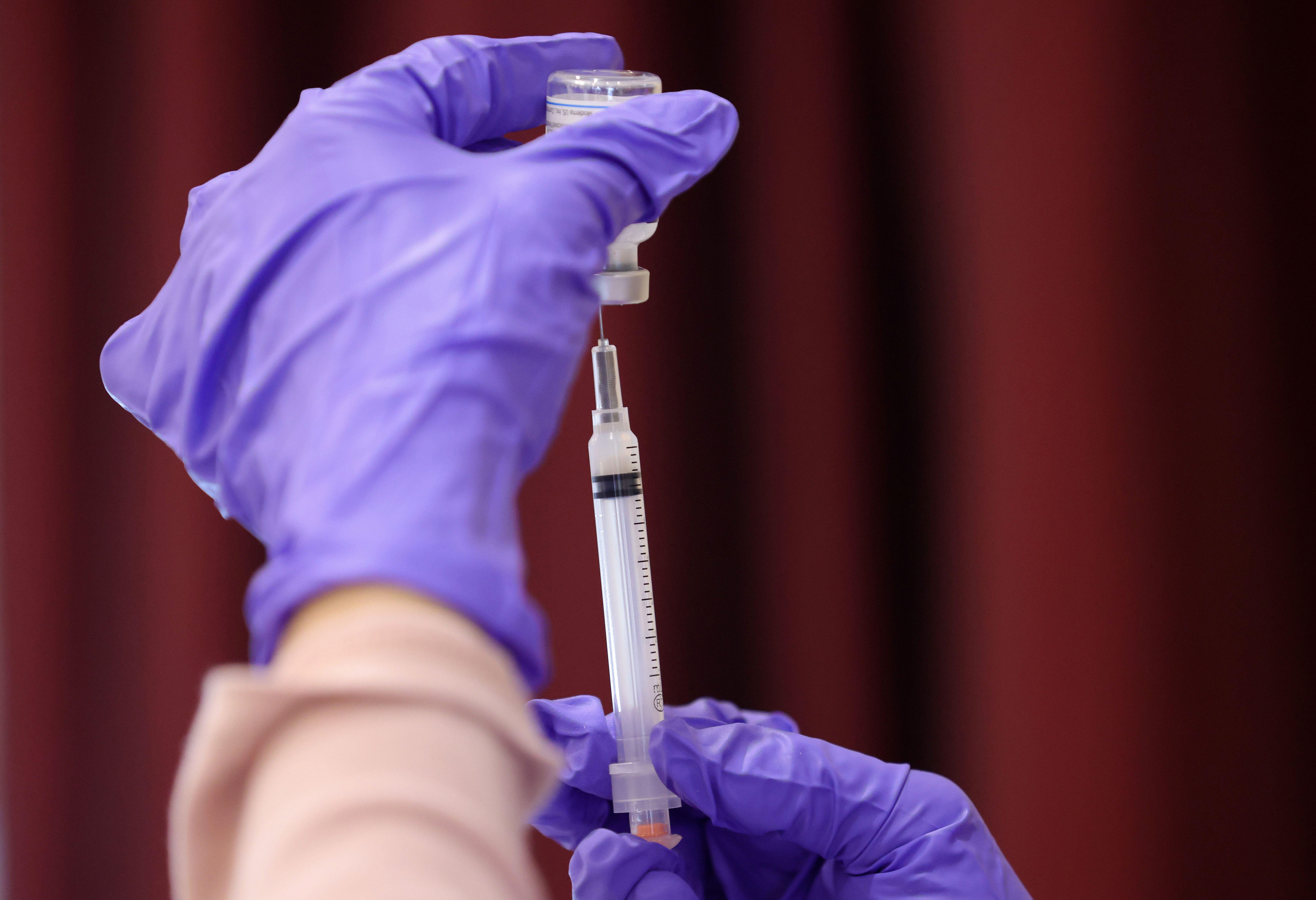 A nurse draws a vaccine dose from a vial as residents receive their second dose of the Moderna Covid-19 vaccine in Bowie, Maryland, on March 25.