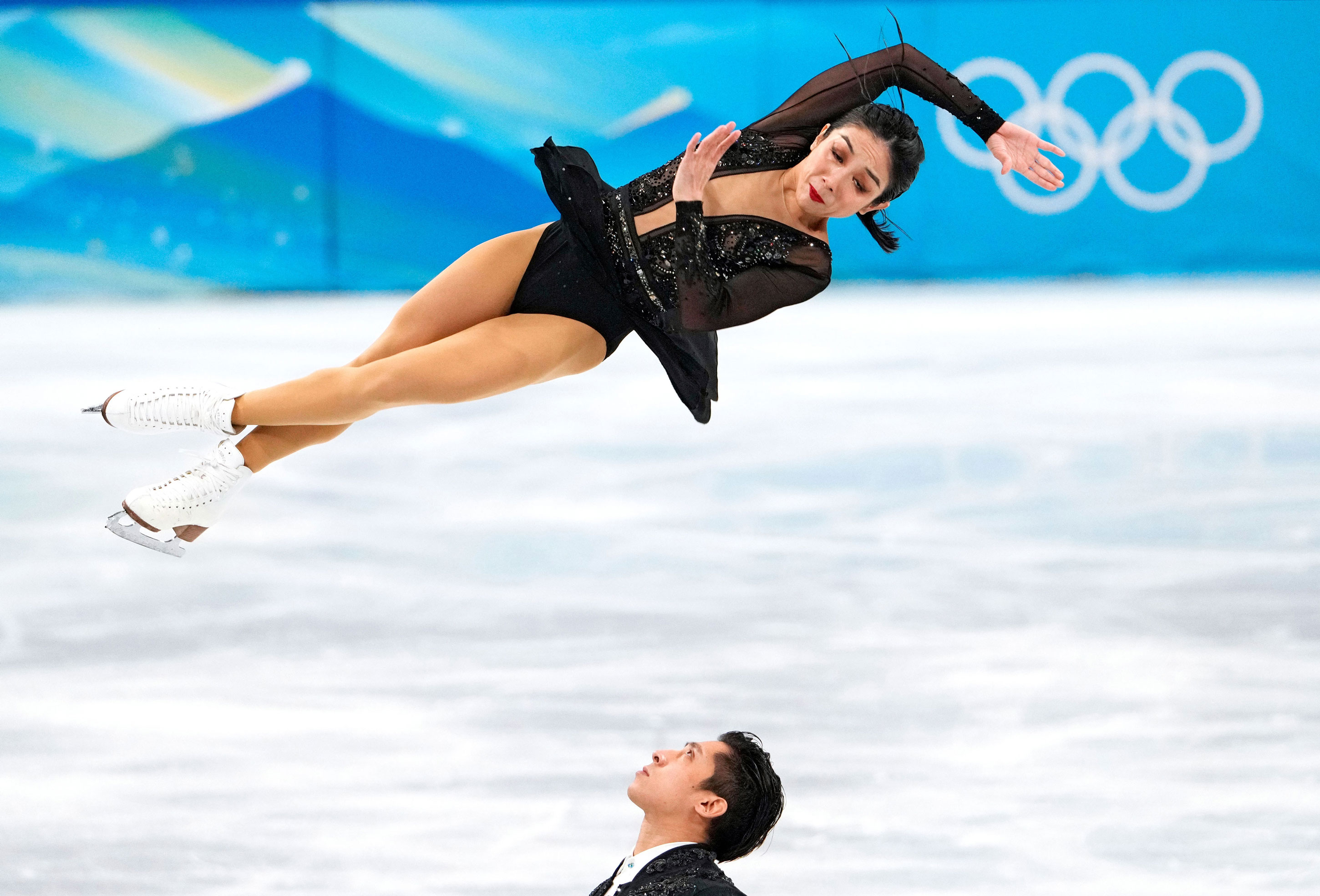 China's Wenjing Sui and Cong Han compete in the figure skating team pairs short program on Friday.