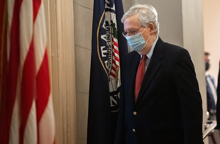 McConnell walks to his office from the Senate Floor on  Friday, December 18.