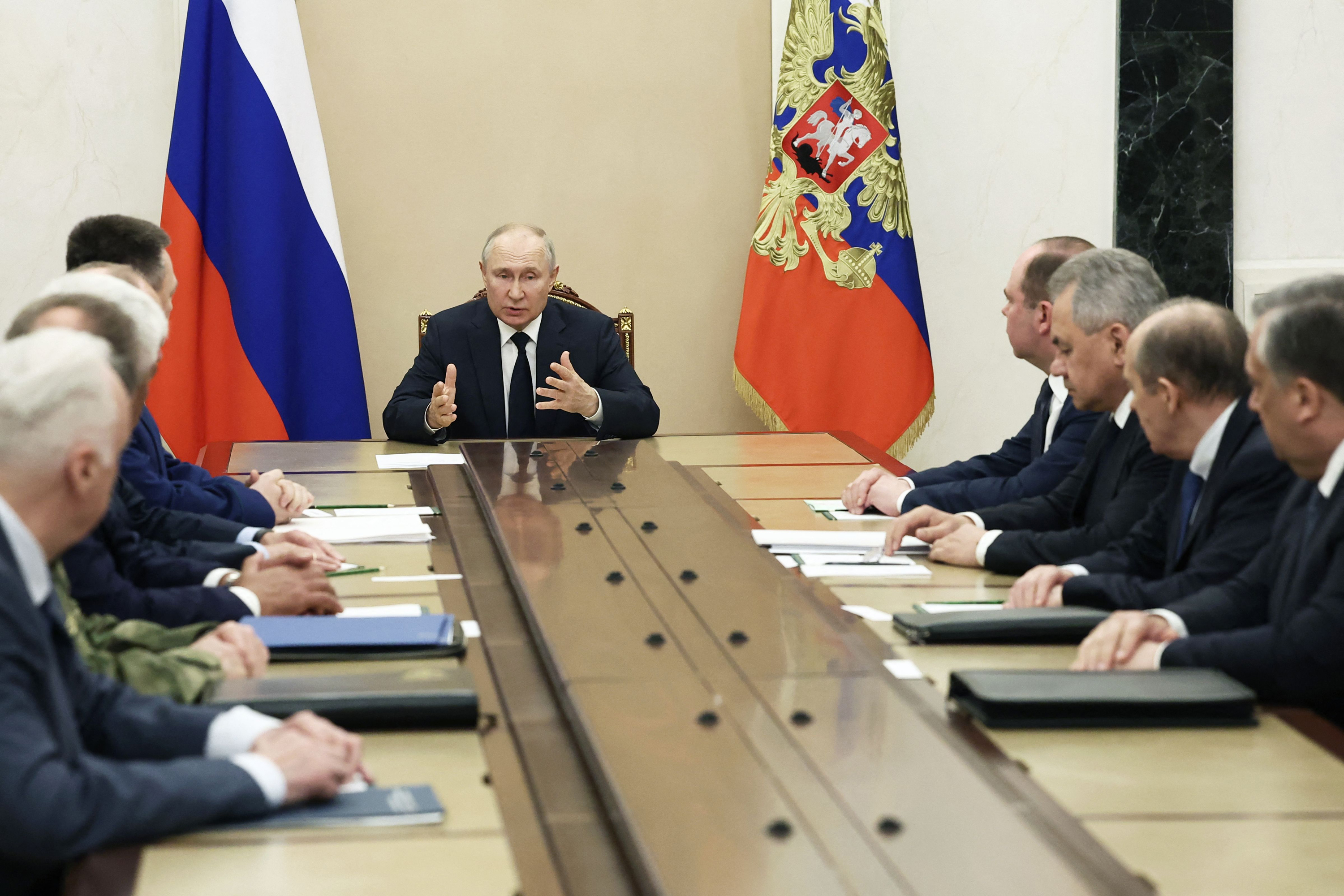 Vladimir Putin meets with Russia's top security officials, in Moscow, on Monday.