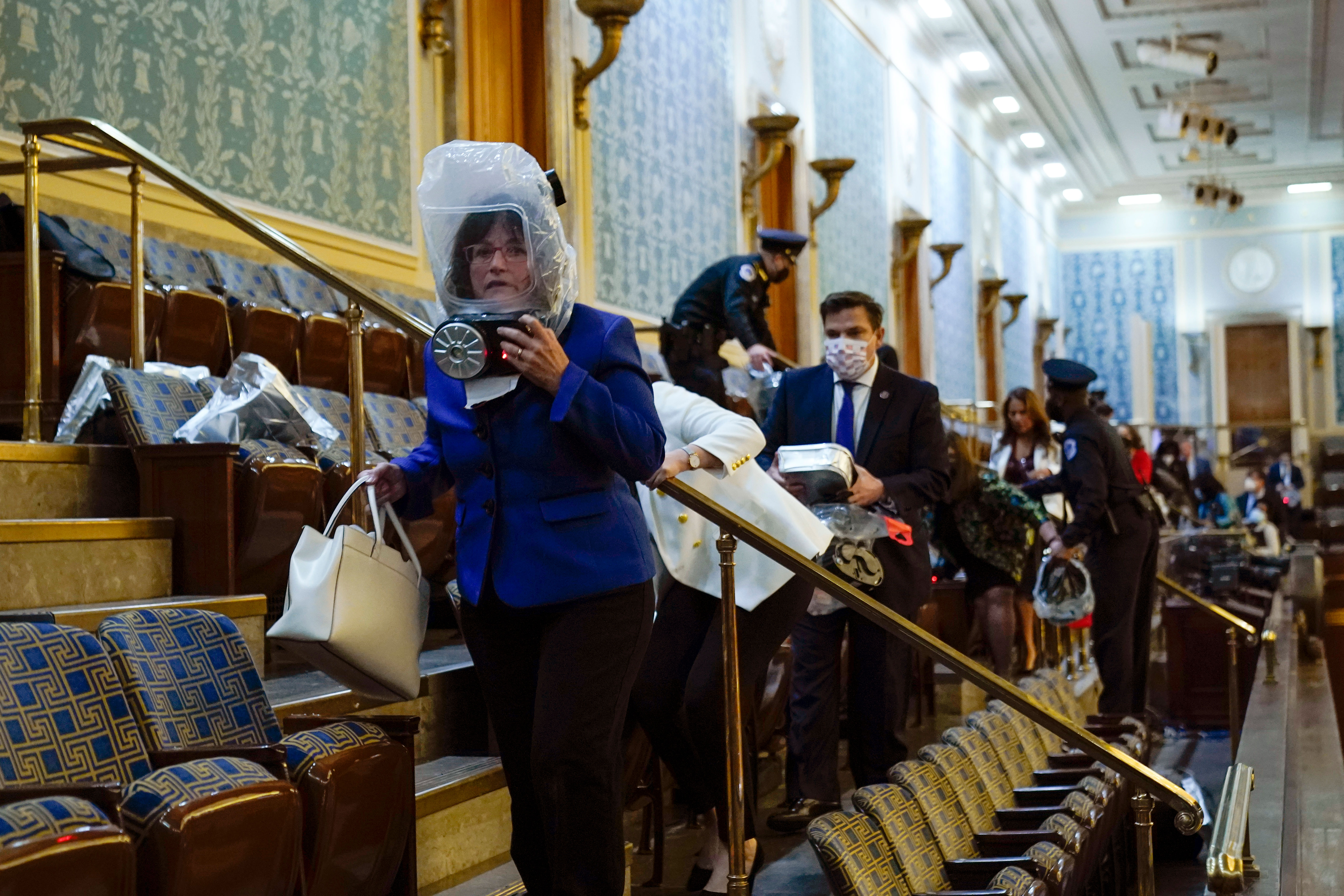 New Hampshire Rep. Annie Kuster, pictured at front in blue, shelters in the House gallery as pro-Trump rioters try to break into the Chamber at the Capitol on January 6.