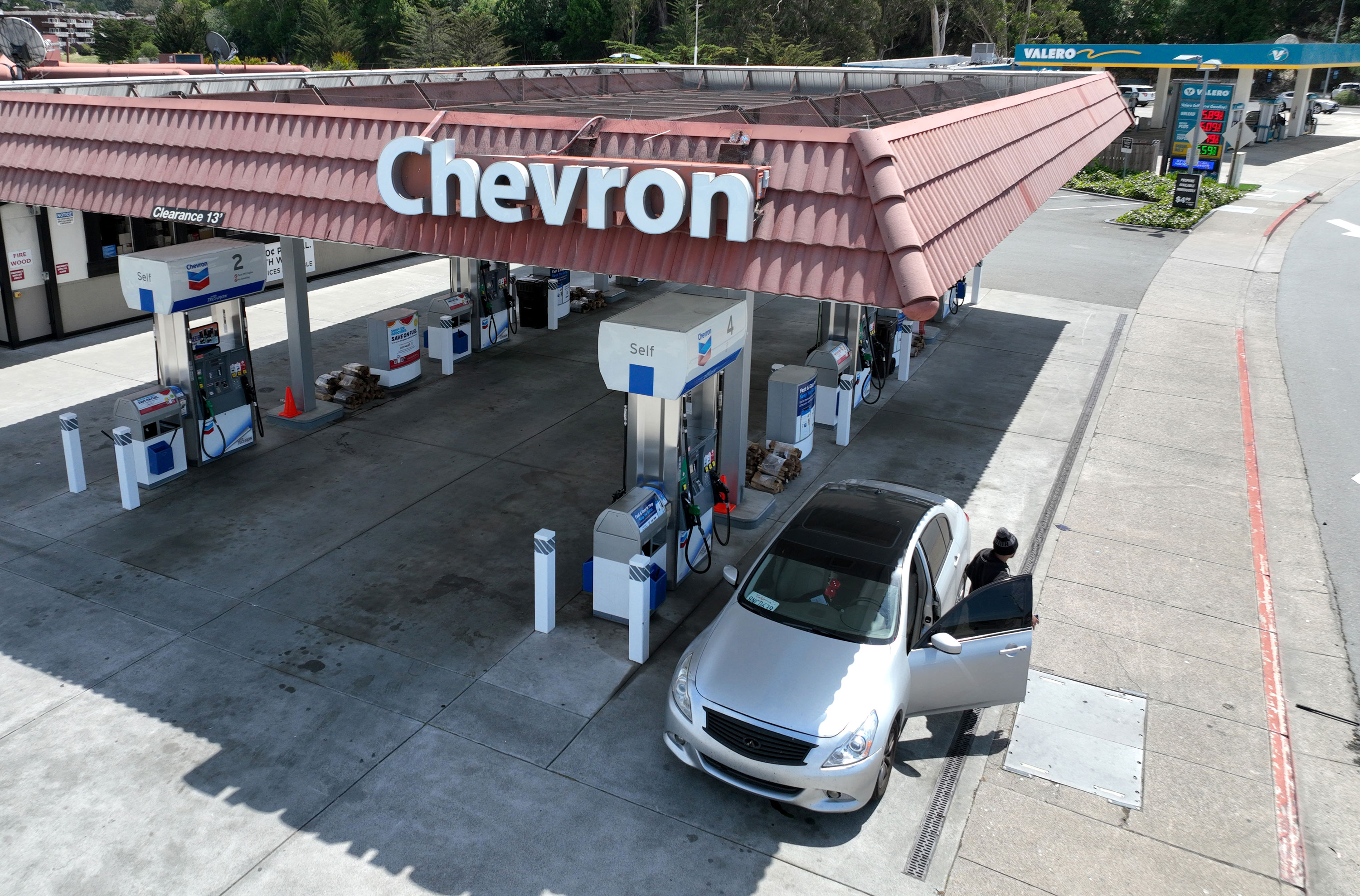In an aerial view, a customer prepares to pump gas into his vehicle at a Chevron gas station on Friday, April 29, in Mill Valley, California.