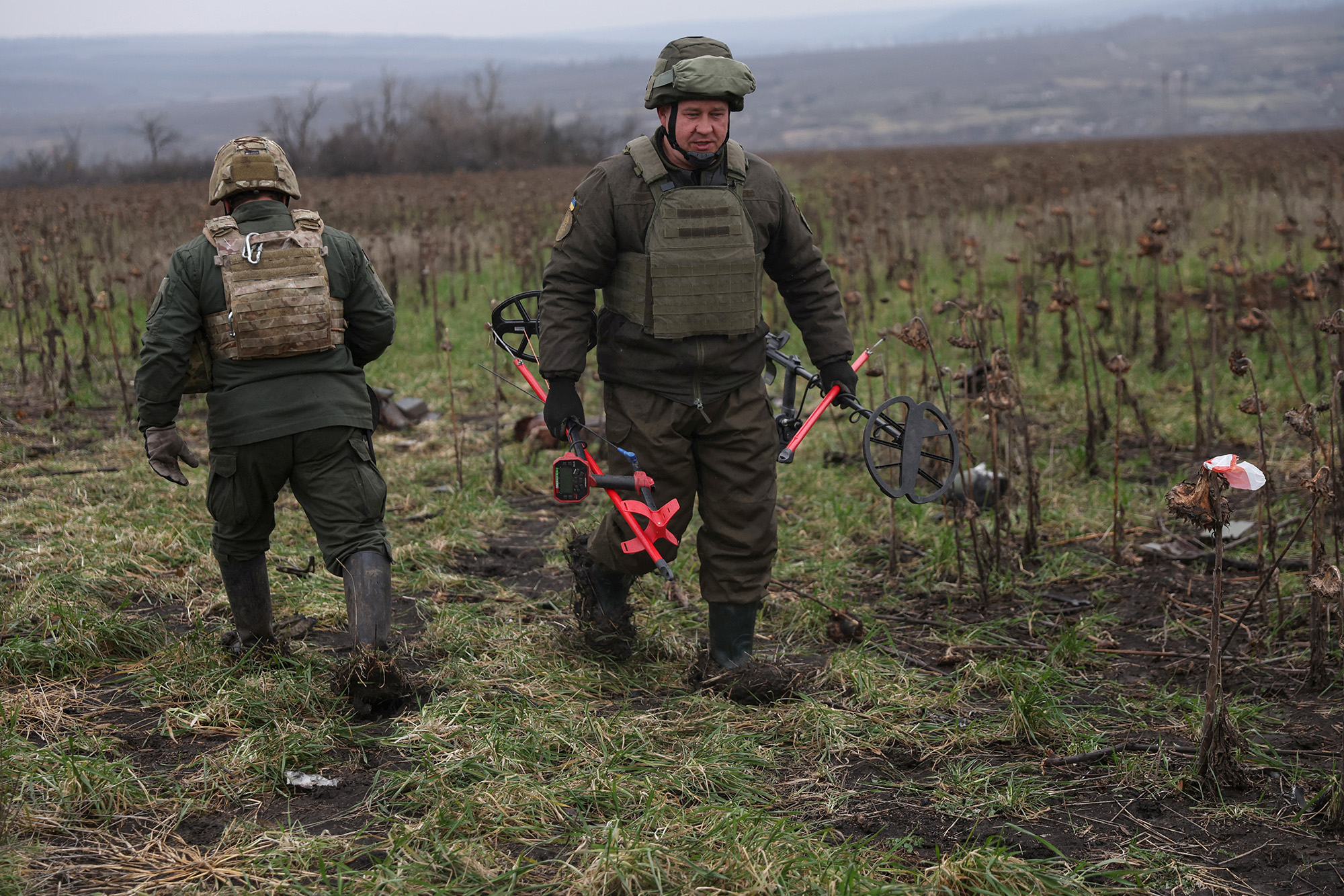Members of the Ukrainian National guard demining team Battalion Dnipro 1 walk in mine fields in the northern part of the Donetsk region of Ukraine, on December 12.