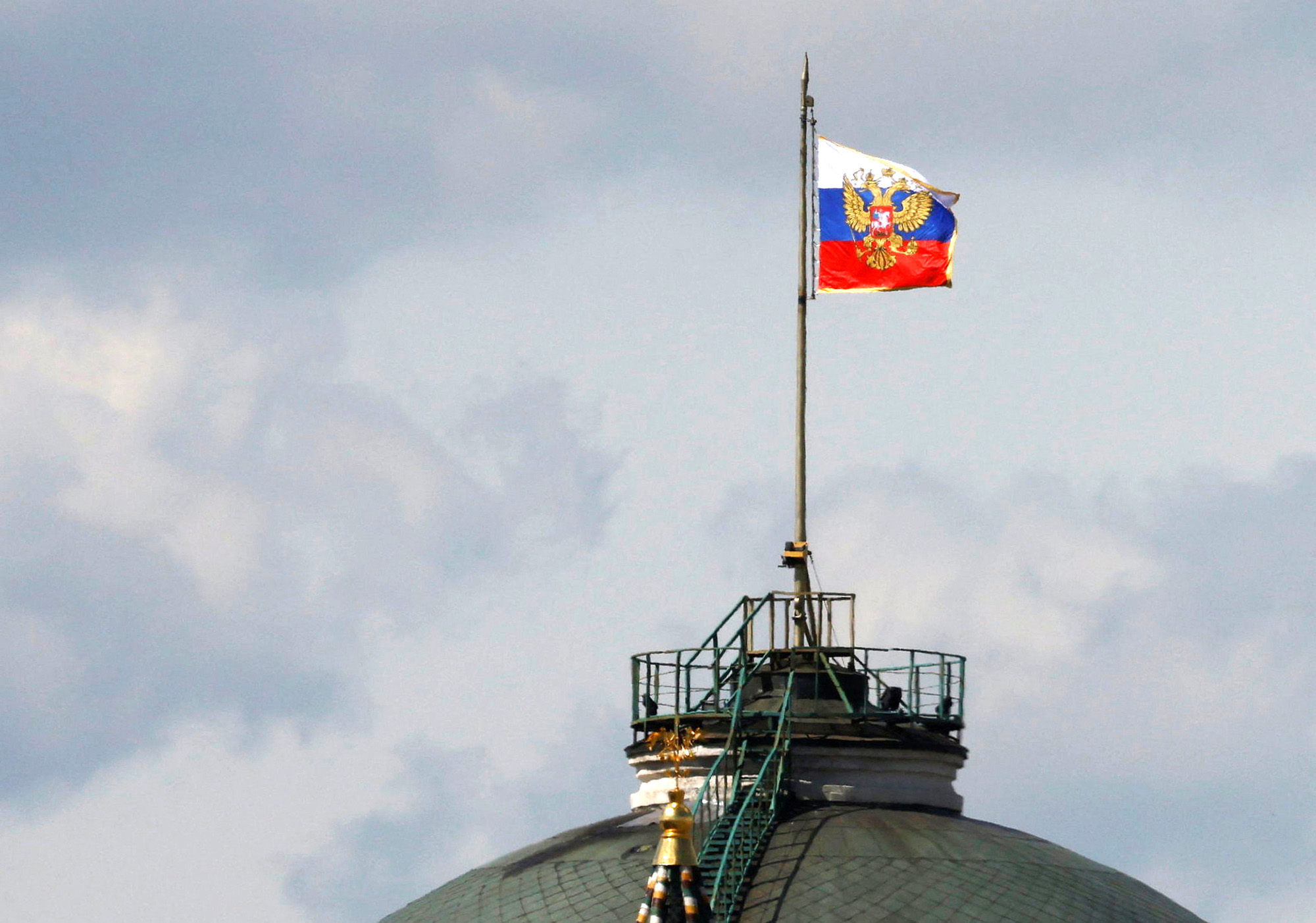 The Russian flag flies on the dome of the Kremlin Senate building, while the roof shows what appears to be marks from the recent drone incident, in central Moscow, Russia, on May 4.