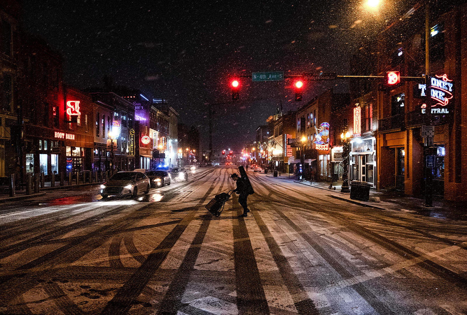 A musician crosses a street in Nashville on December 22.