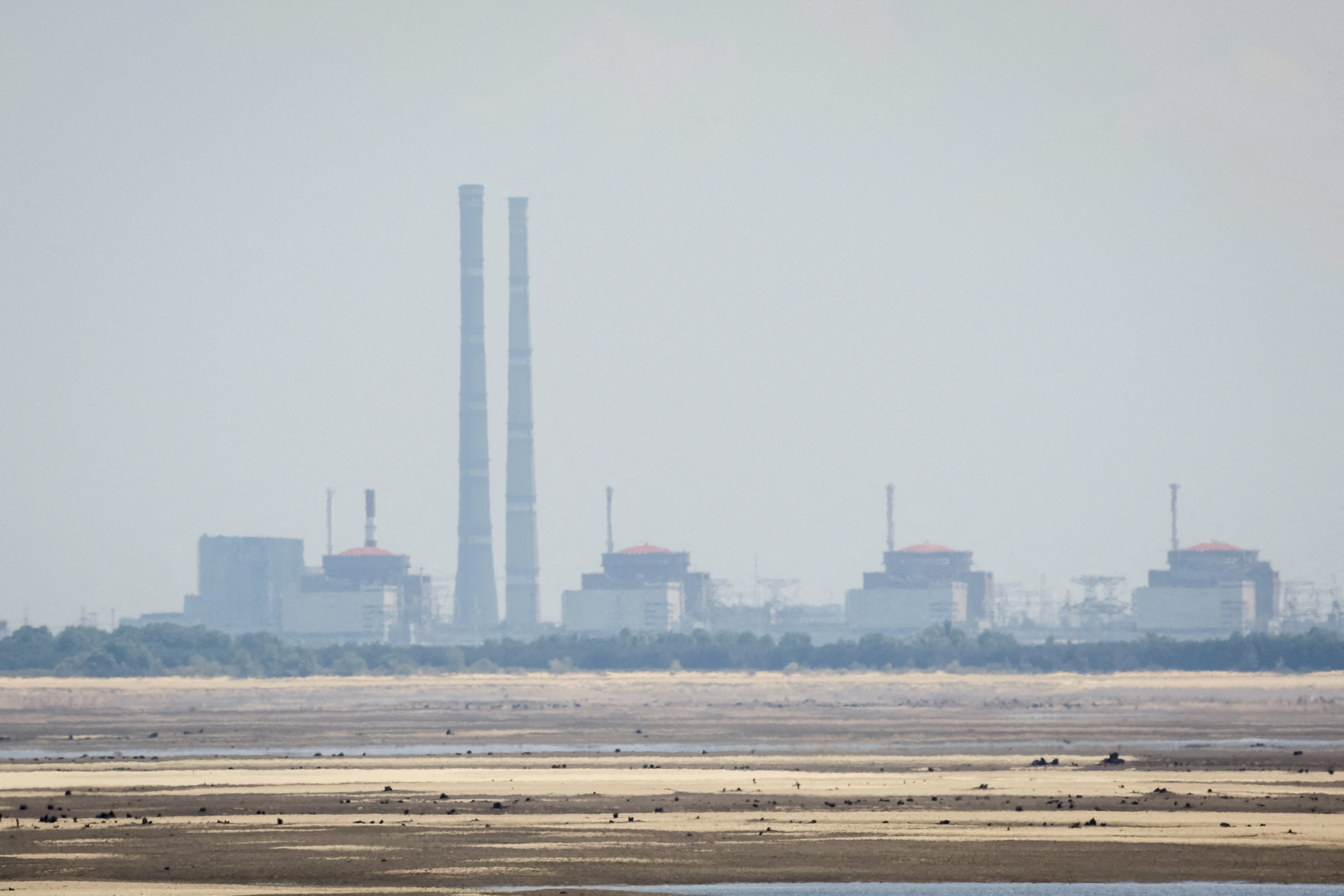 A view shows Zaporizhzhia Nuclear Power Plant from the bank of Kakhovka Reservoir near the town of Nikopol after the Nova Kakhovka dam breach in the Dnipropetrovsk region, Ukraine, on June 16, 2023.