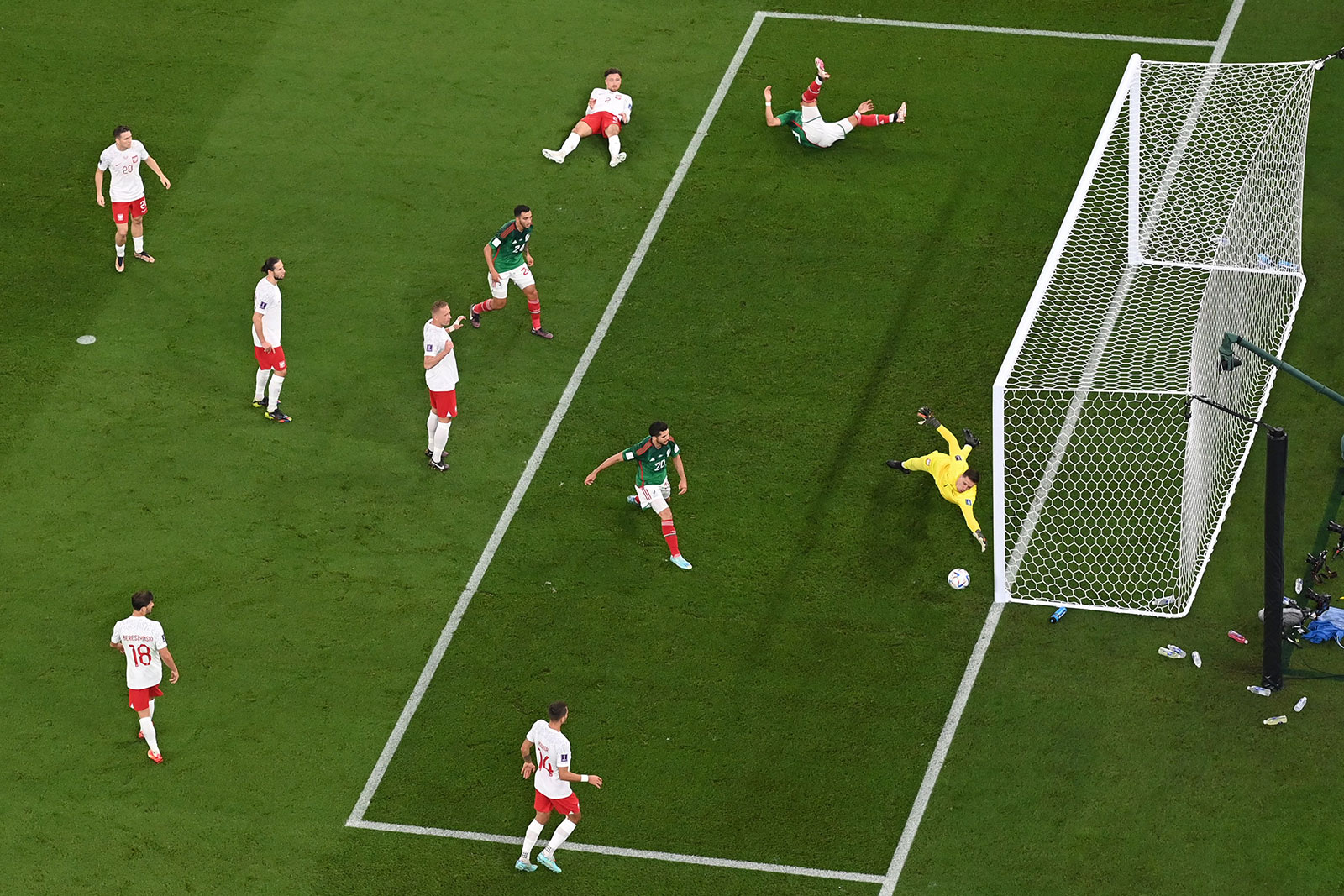 Mexico's forward Alexis Vega, top right, heads the ball towards the goal during the match between Mexico and Poland on November 22.