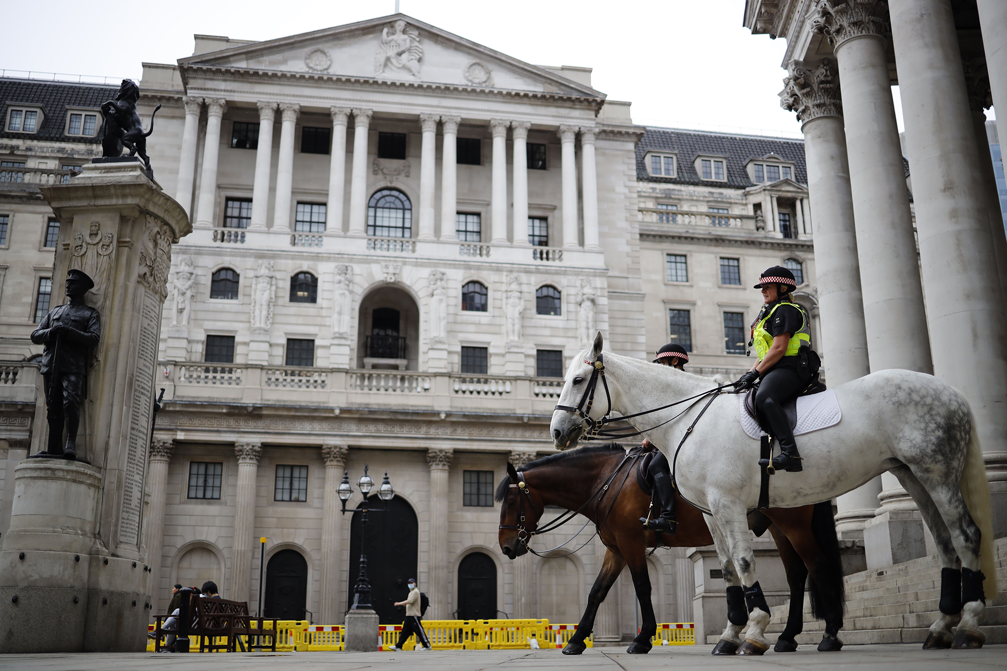 Mounted police officers sit in outside the Royal Exchange and the Bank of England in London on June 17, 2020.