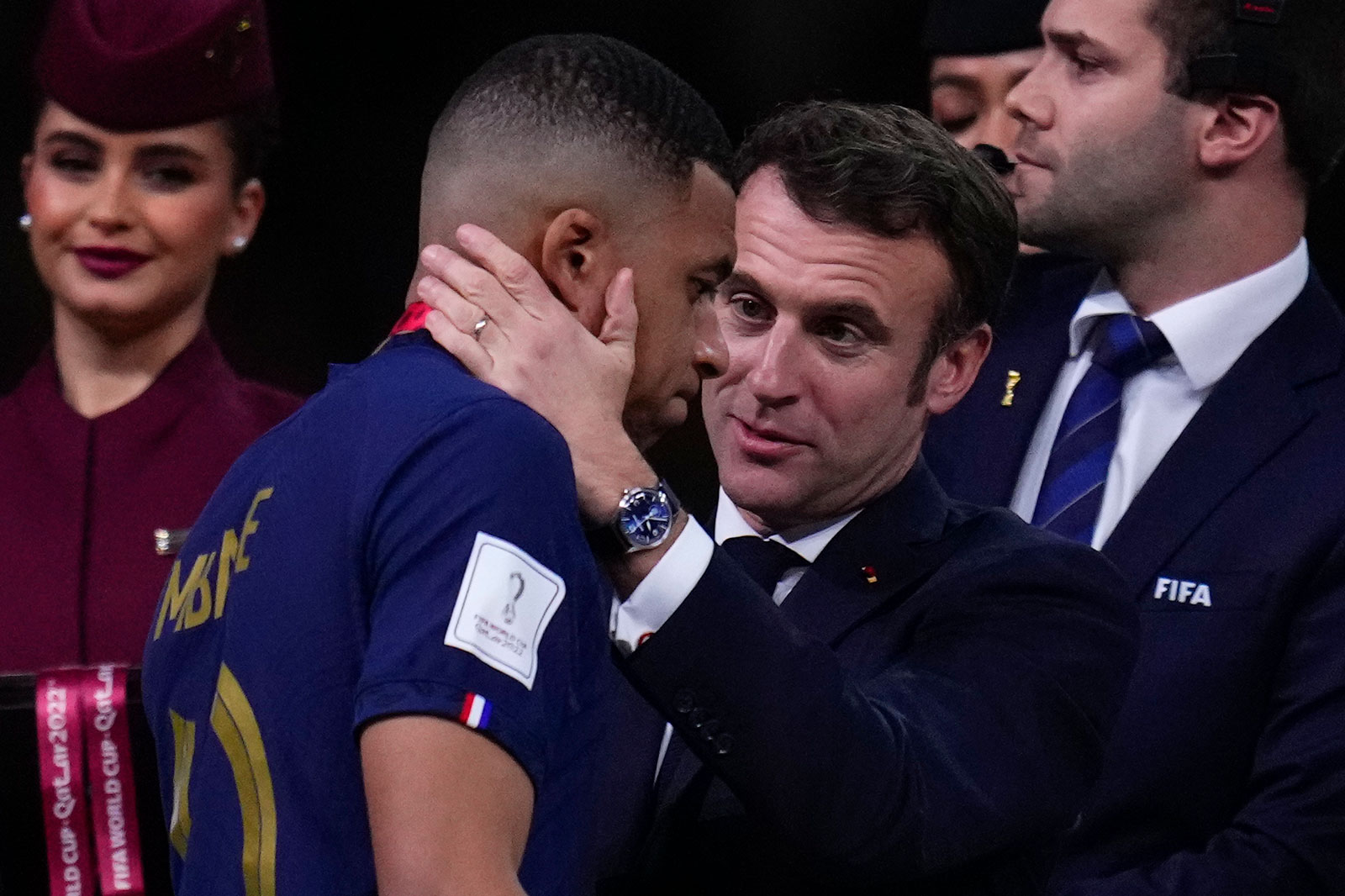 French President Emmanuel Macron consoles France's Kylian Mbappé after the World Cup soccer match final against Argentina on Sunday. 