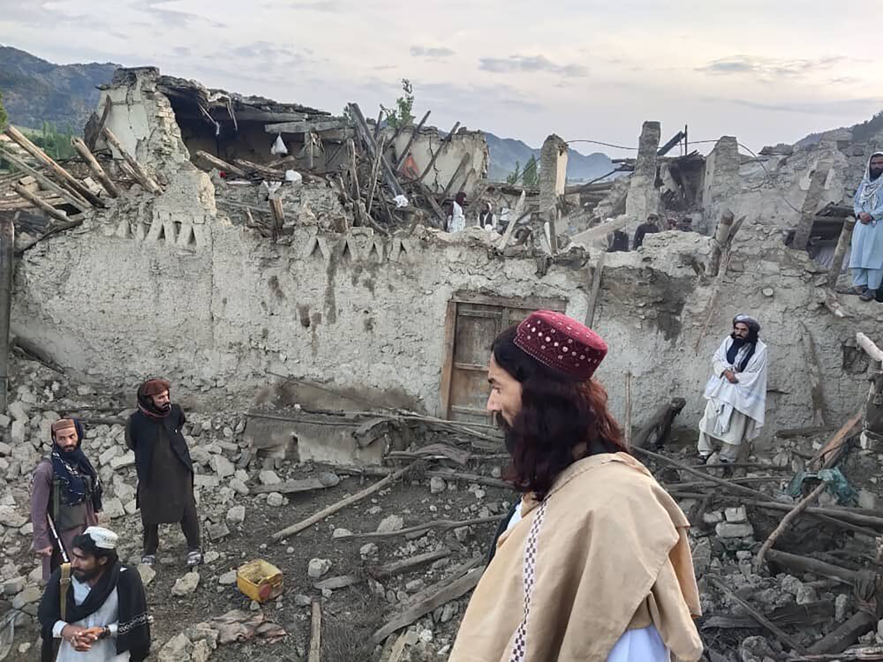 People look at destruction caused by an earthquake in the province of Paktika, eastern Afghanistan, on Wednesday, June 22.