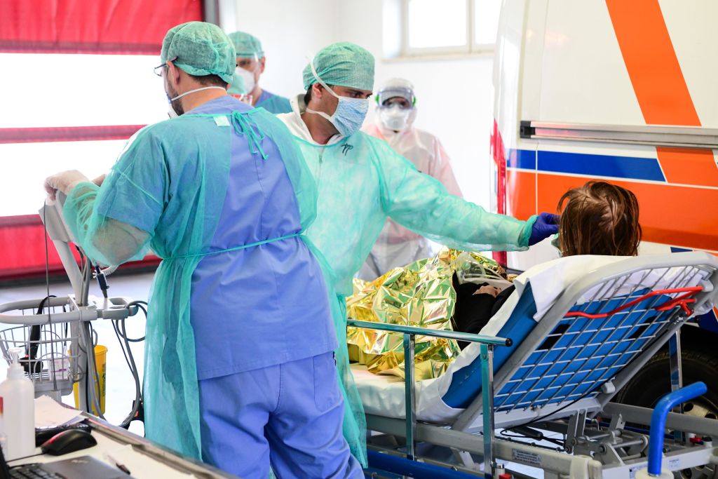 A medical worker tends to a patient in a hospital in Lombardy.