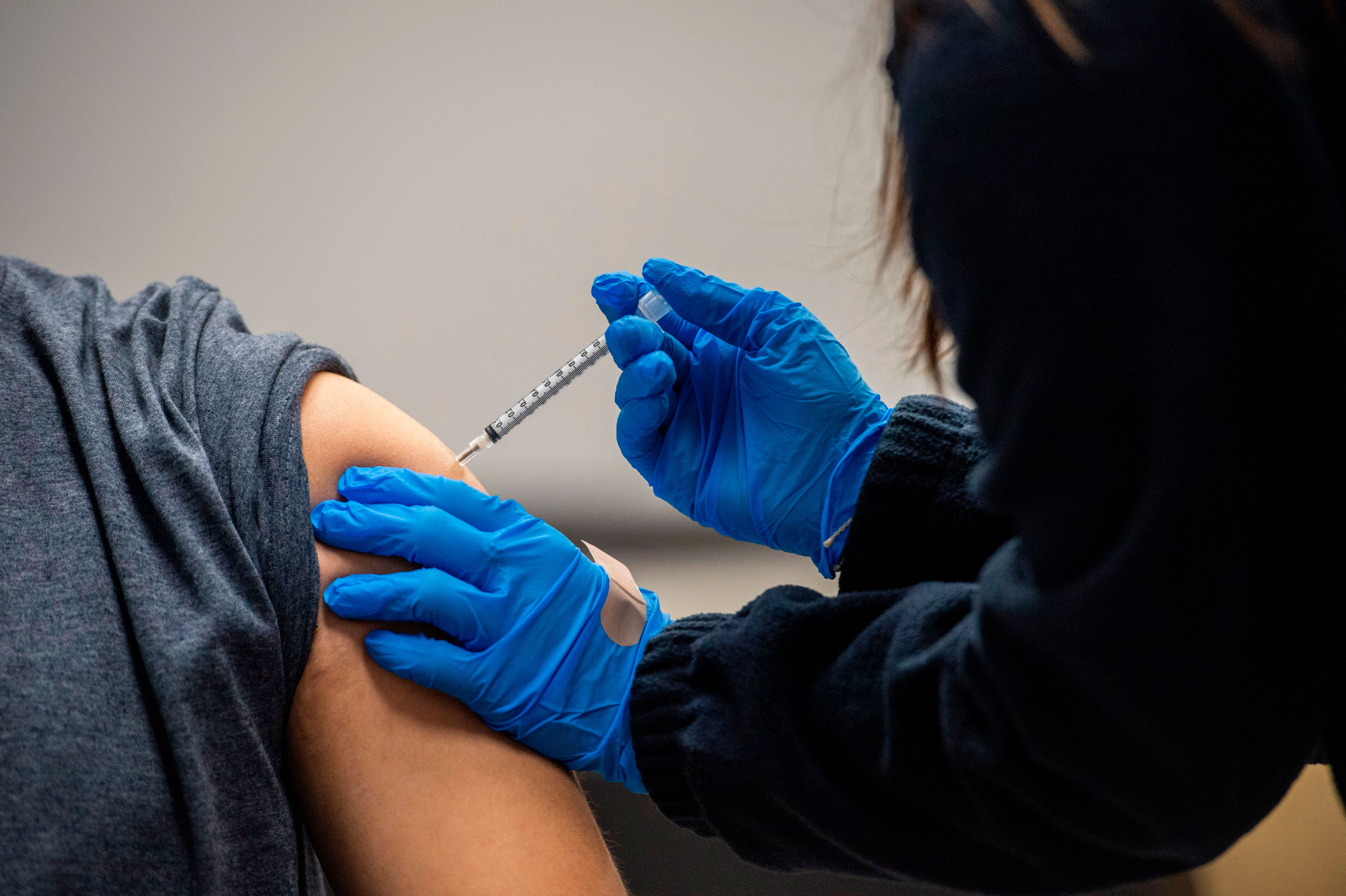 A person receives the Pfizer-BioNTech Covid-19 vaccine in Chelsea, Massachusetts, on February 16.