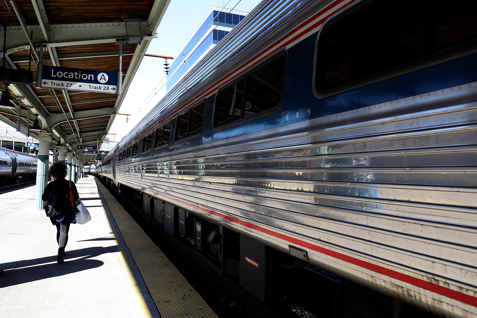 A passenger walks to a departing Amtrak train at Union Station on April 9, in Washington.