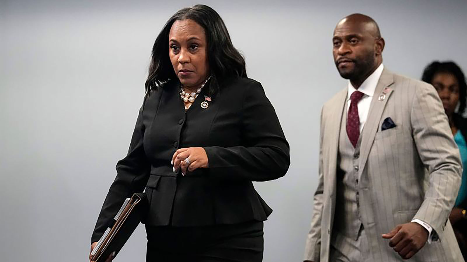Fulton County District Attorney Fani Willis enteres a room in the Fulton County Government Center ahead of a news conference, Monday, August 14, in Atlanta. 