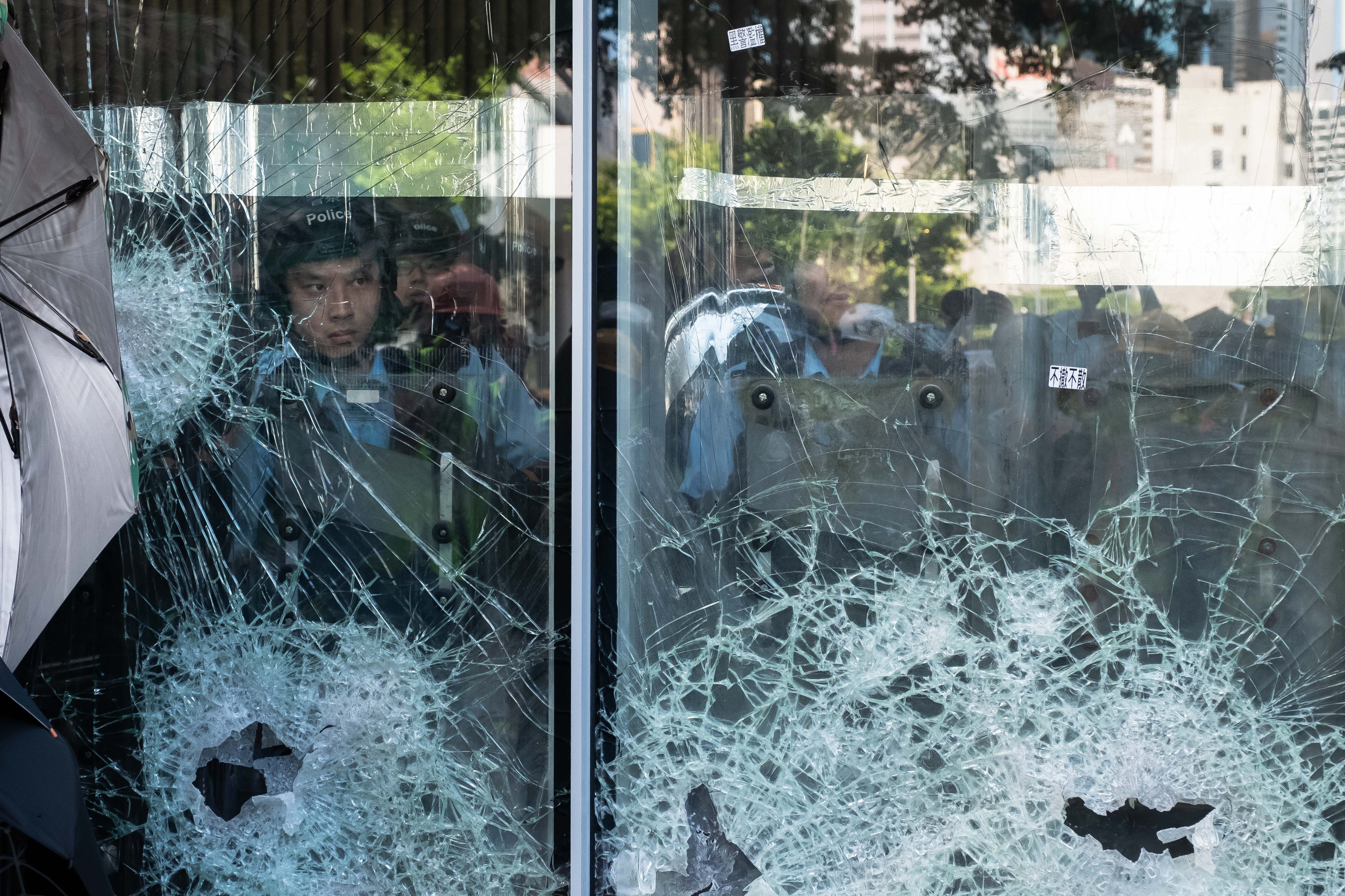 Protesters smash glass doors and windows of the Legislative Council complex on July 01, 2019 in Hong Kong.