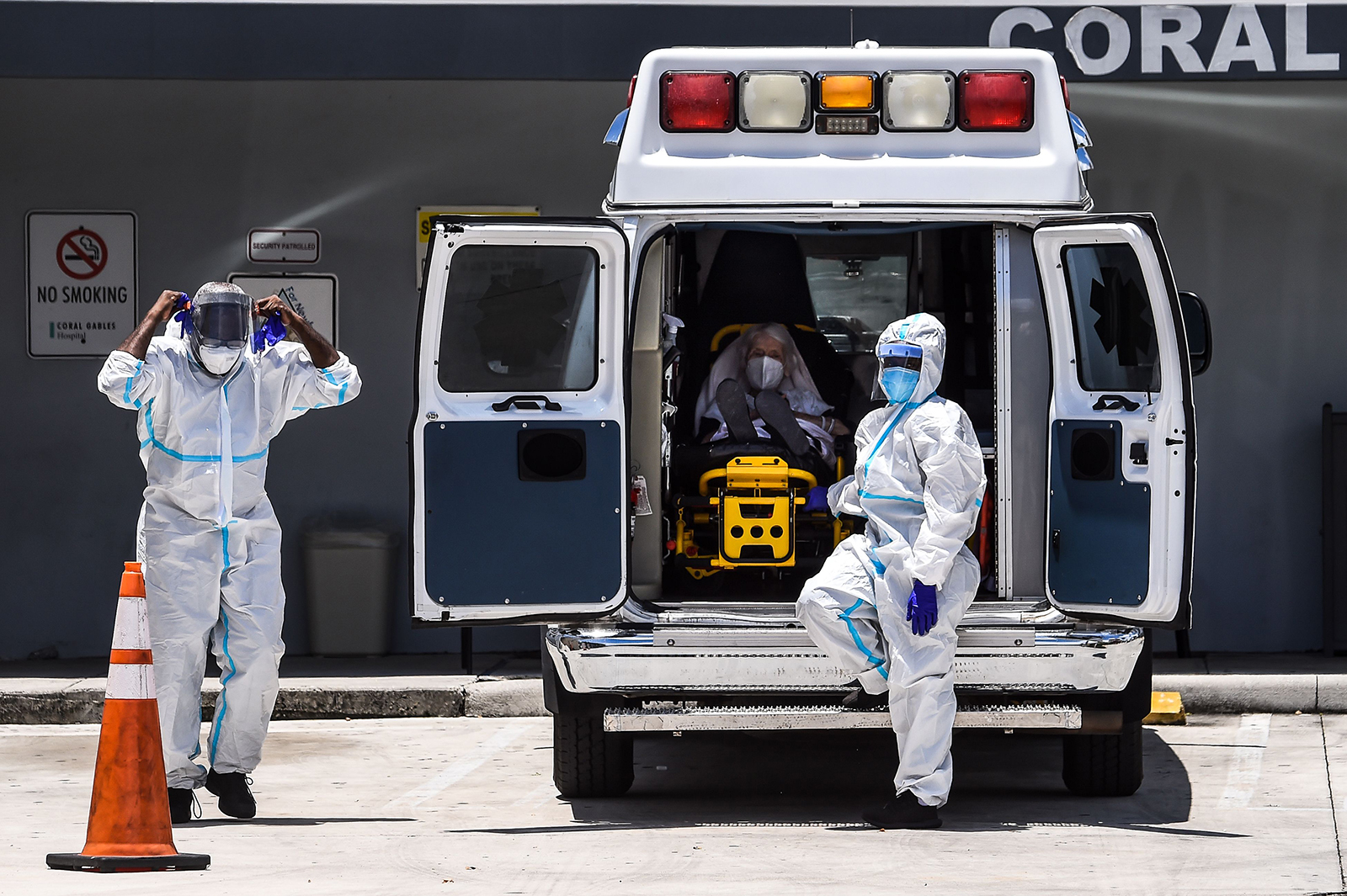 Medics prepares to transfer a patient on a stretcher from an ambulance outside of Emergency at Coral Gables Hospital where Coronavirus patients are treated in Coral Gables near Miami, on July 30.