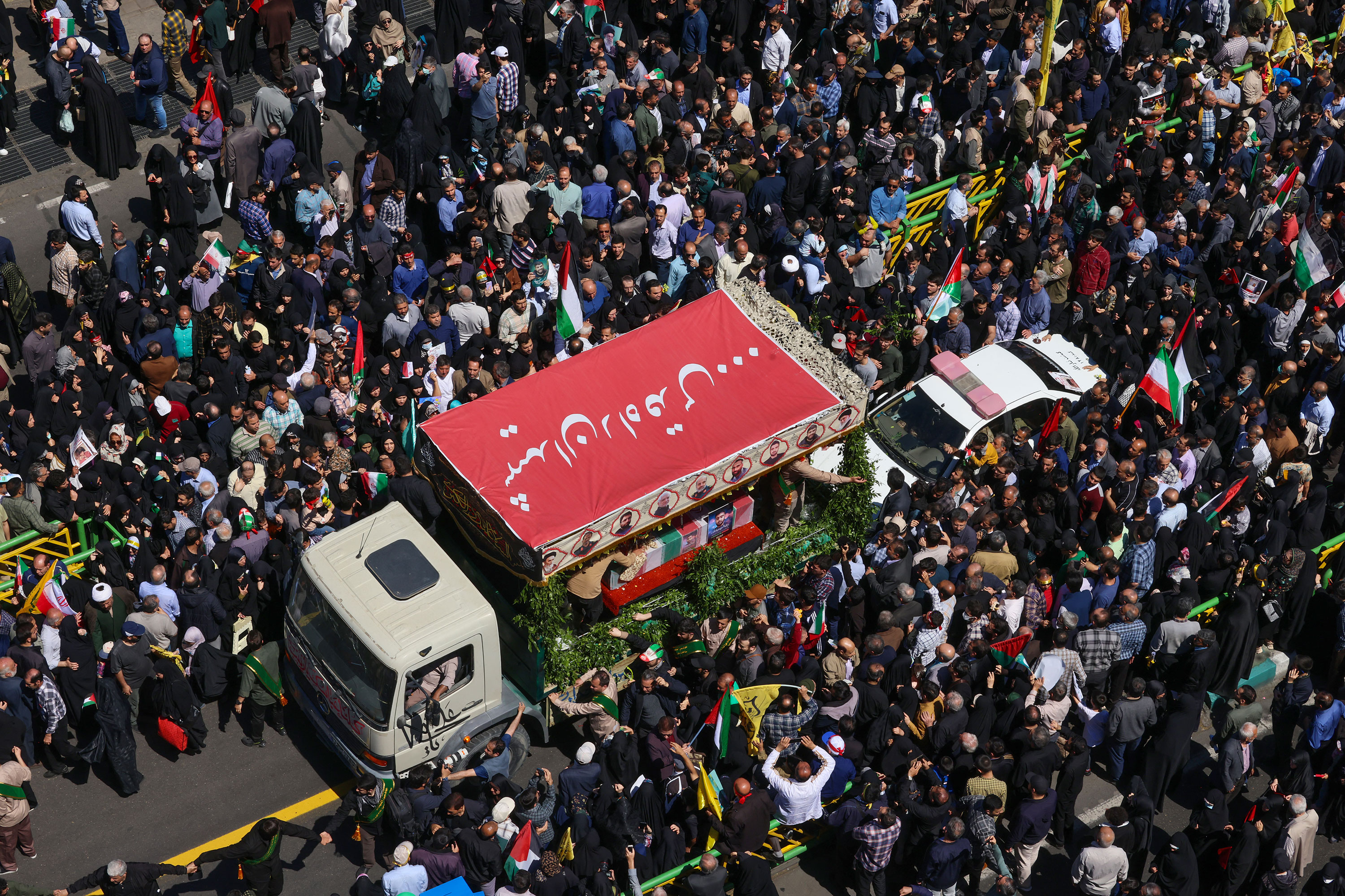 People attend the funeral procession for seven Islamic Revolutionary Guard Corps members killed in a strike in Syria, which Iran blamed on Israel, in Tehran on April 5. 