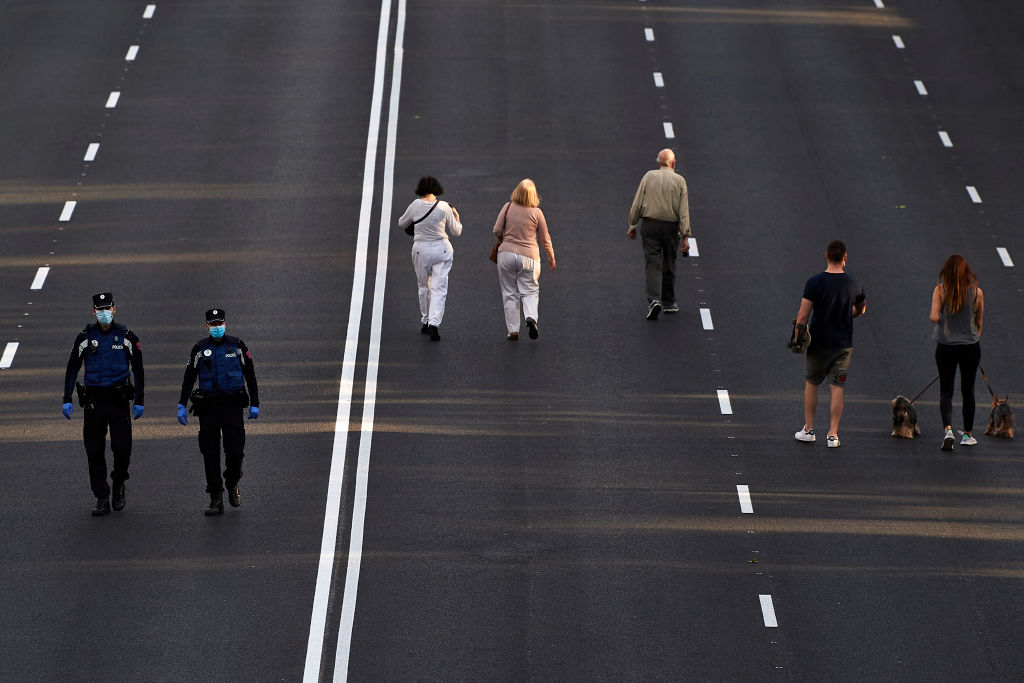  People walk on Paseo de la Castellana, a major street in Madrid which has been pedestrianized. 