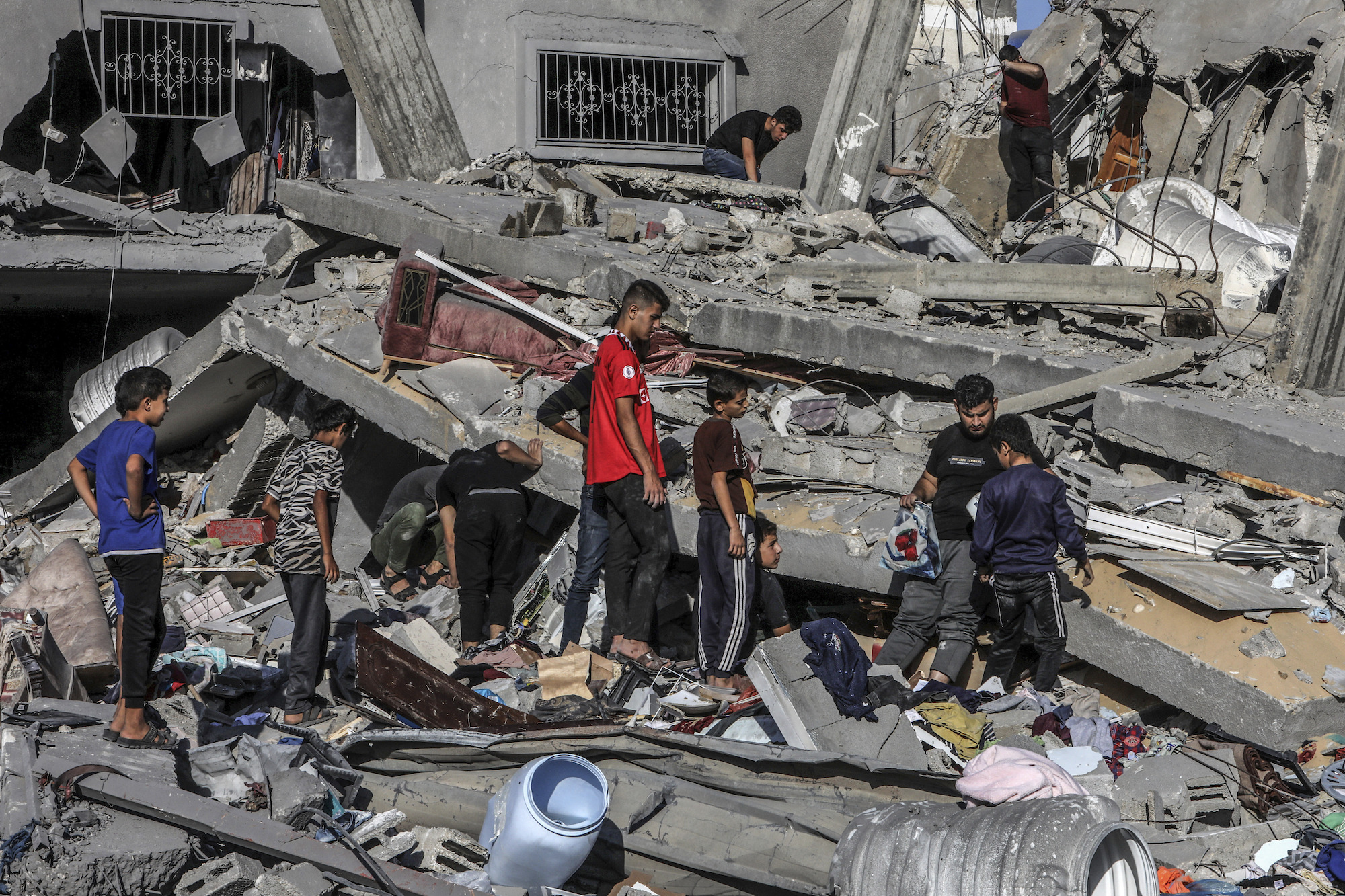Palestinians inspect a house destroyed by an Israeli airstrike in Rafah, Gaza, on Saturday.