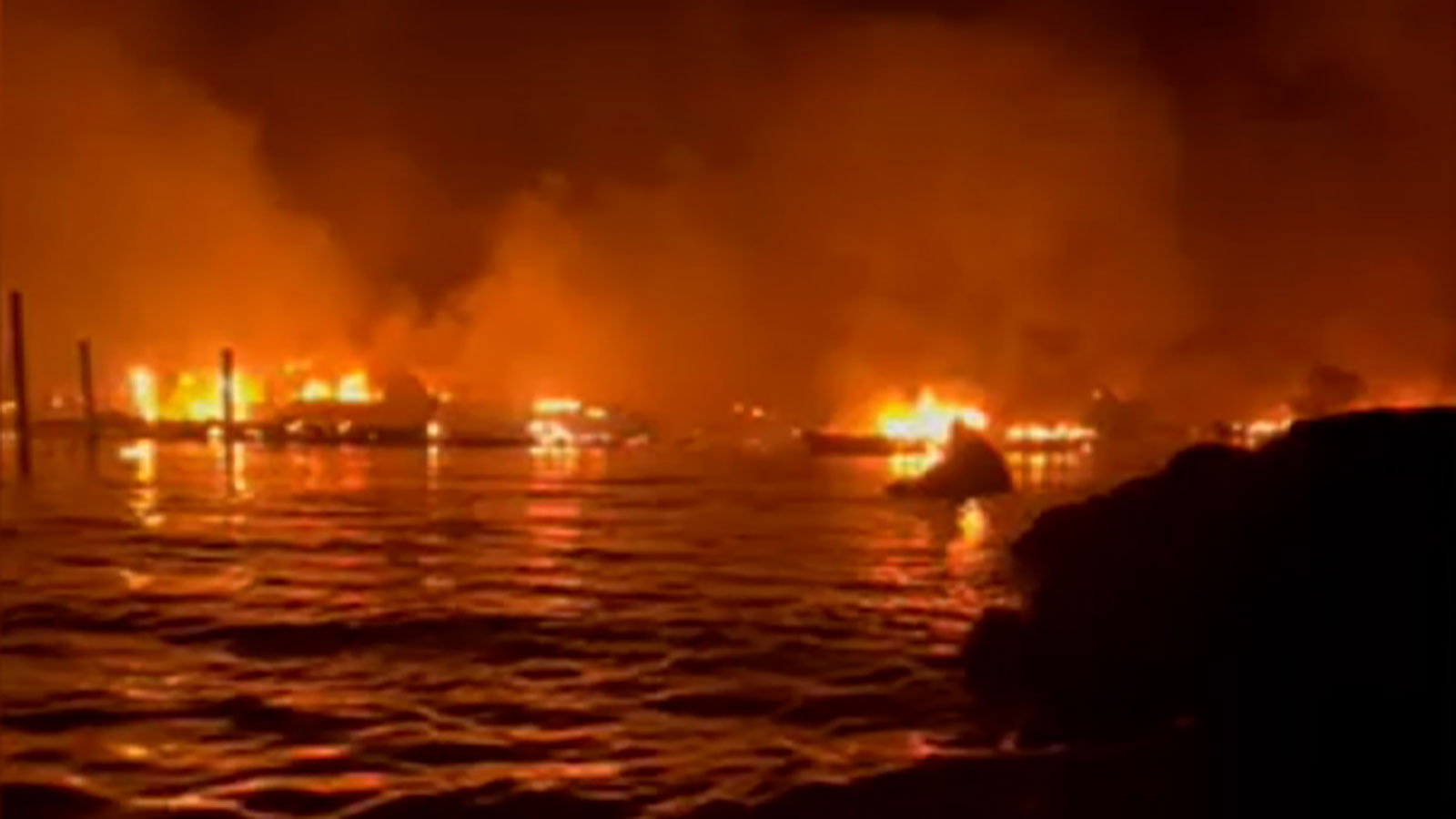 Emma Nelson recorded video from a boat offshore showing structureson land and boats in the water on fire as Lahaina burned Tuesday night. 
