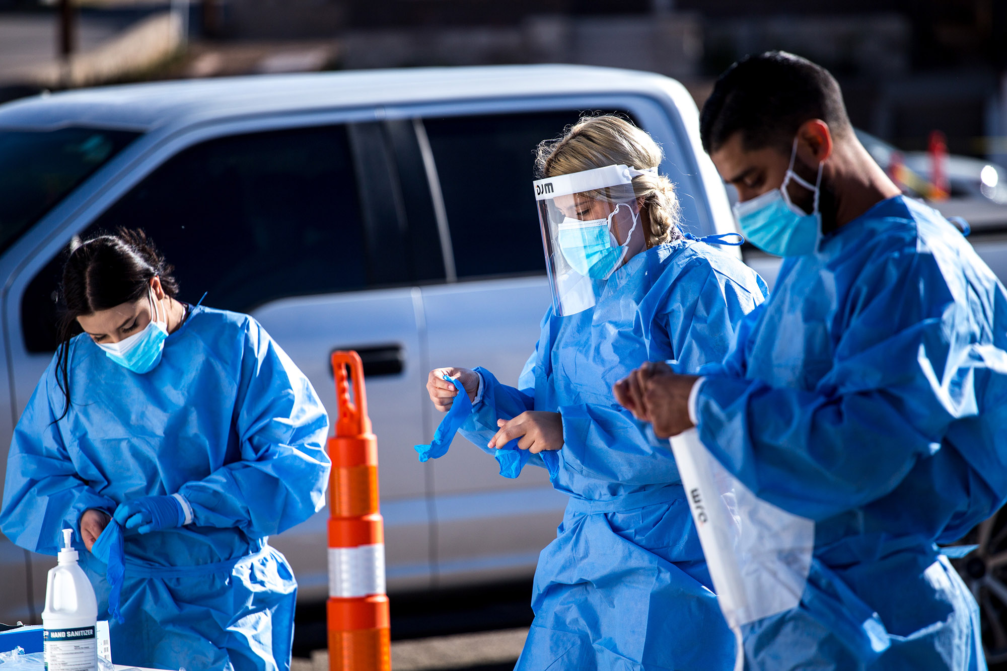 Medical workers put on personal protective equipment (PPE) before starting shifts at a Covid-19 drive-thru testing site in El Paso, Texas, on Monday, November 9. 