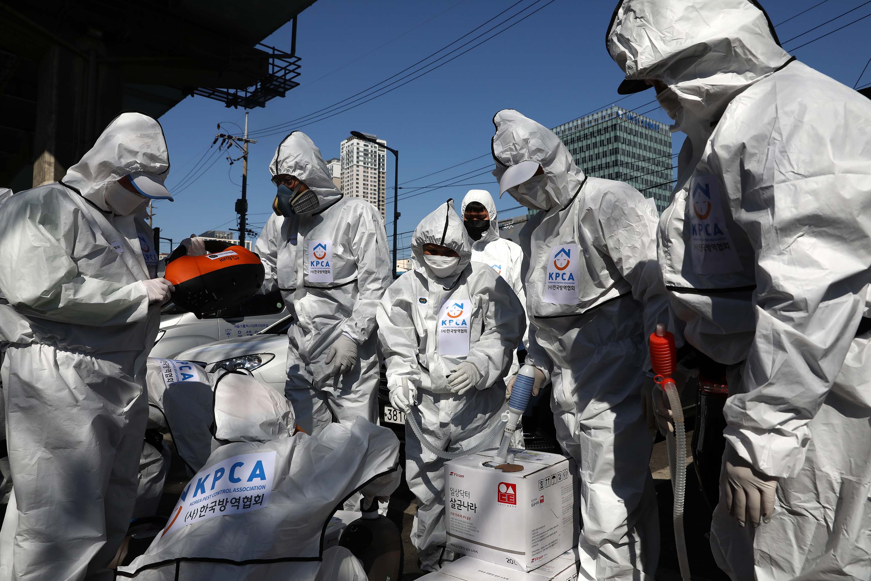 Workers prepare to disinfect a neighborhood in Seoul, South Korea, on Sunday.