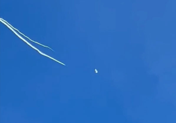 A still from Joey Lopes' video of the balloon being shot down Saturday, February 4. 