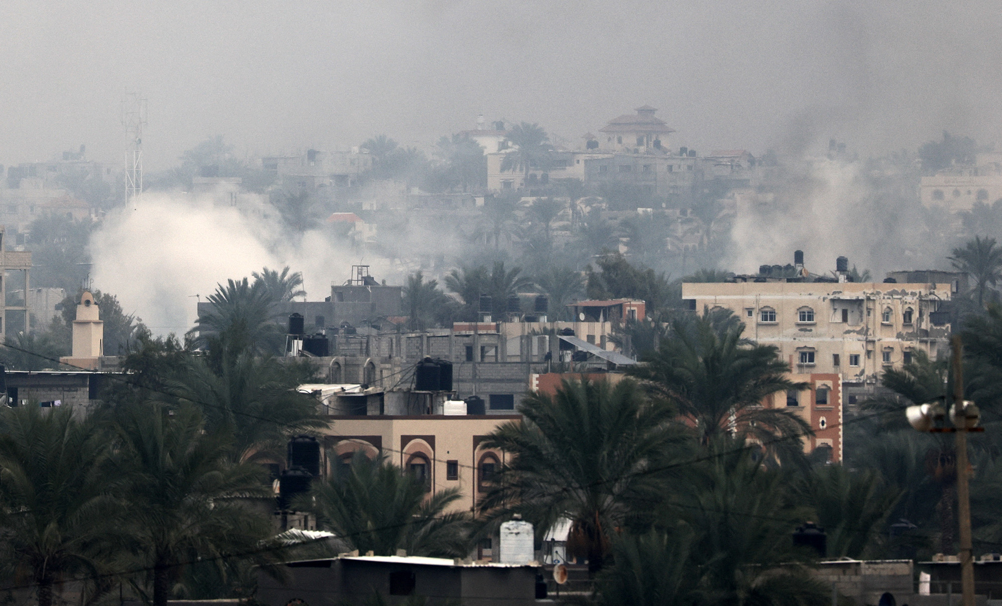 Smoke rises above buildings in Khan Younis, Gaza, on December 5.