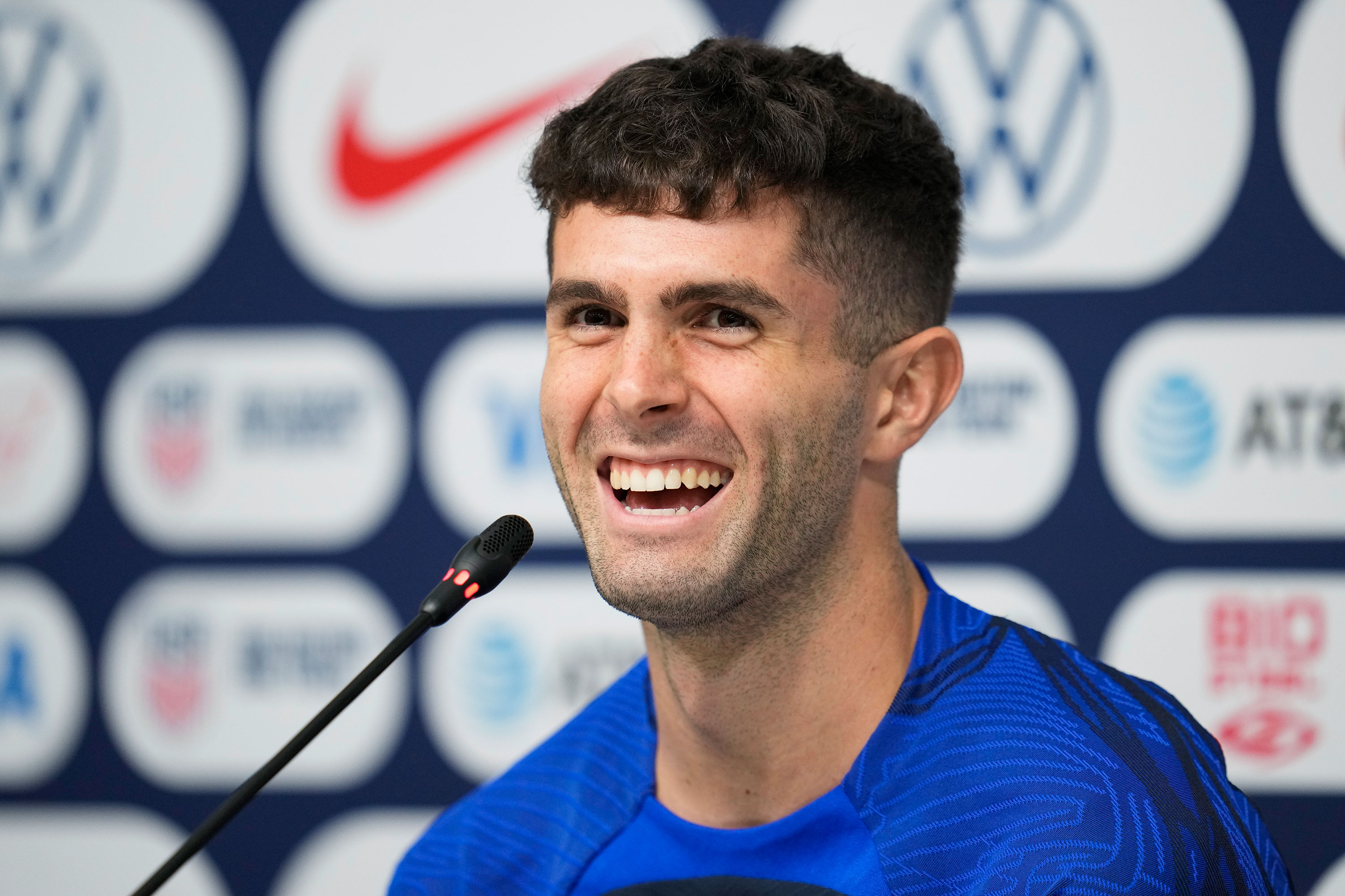 Christian Pulisic laughs during a press conference on Thursday.