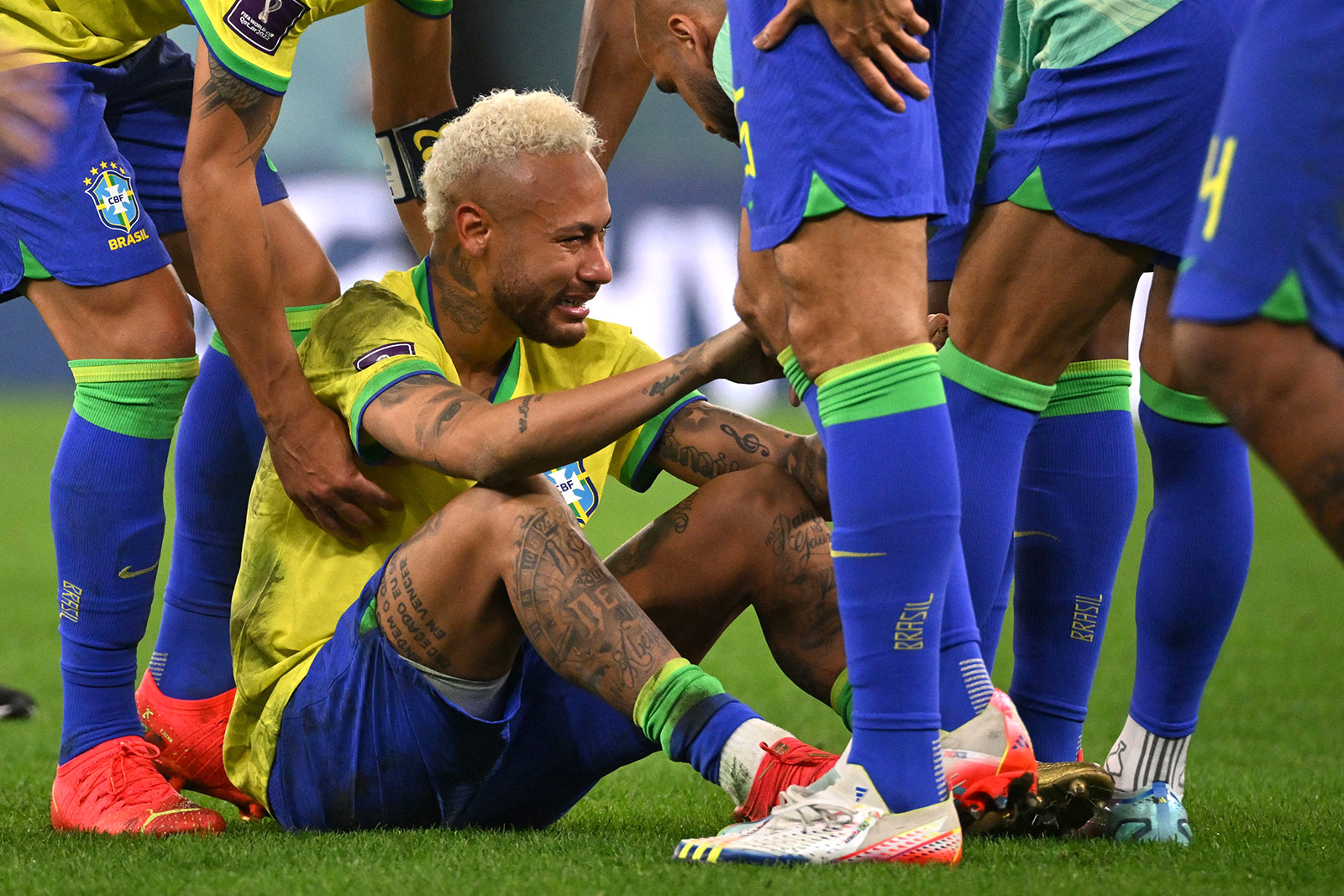 Brazilian Neymar is consoled by his team-mates after losing to Croatia on December 9. 