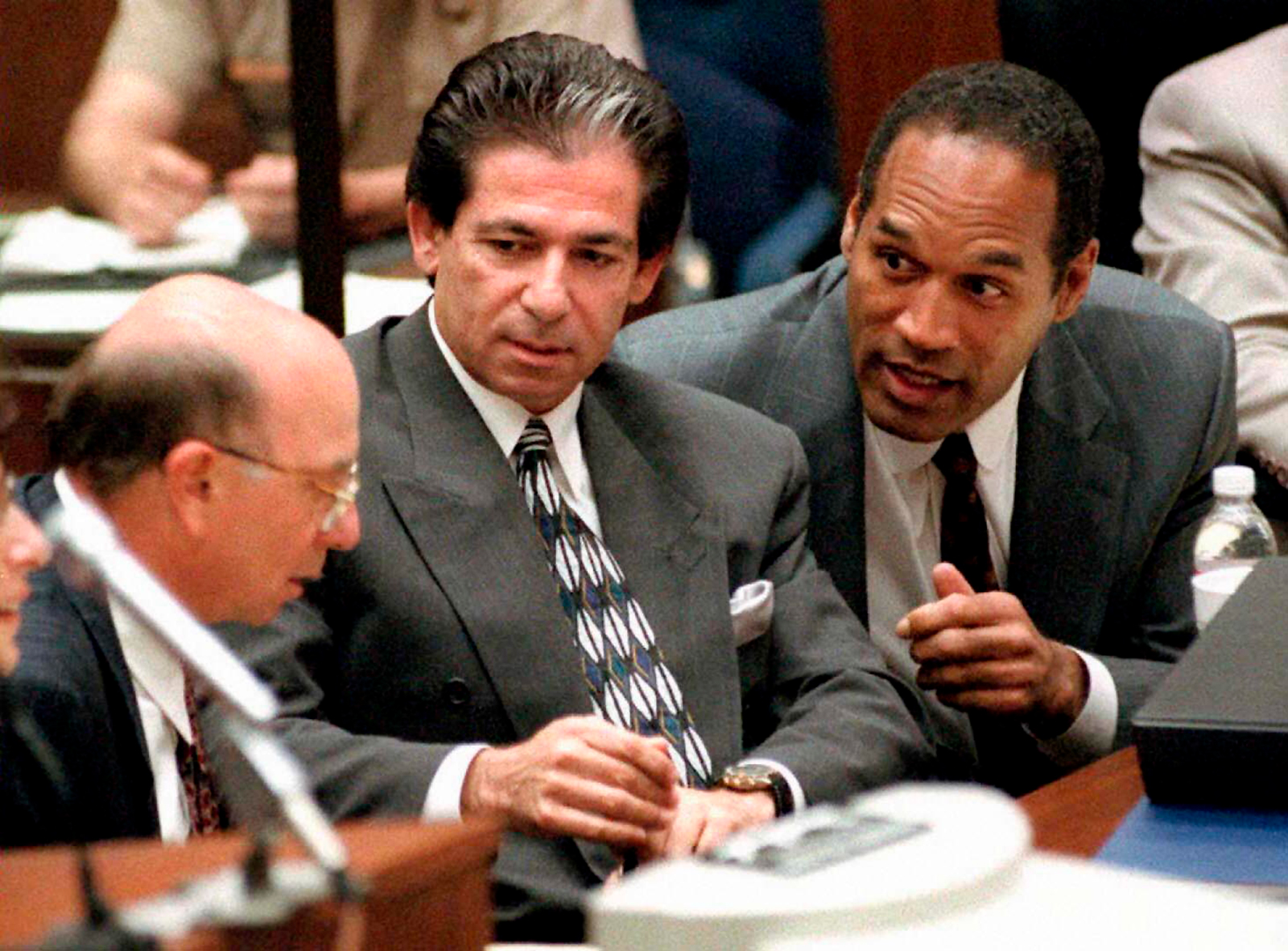 O.J. Simpson consults with Robert Kardashian, center, and Alvin Michelson, left, during a hearing in Los Angeles in May 1995.