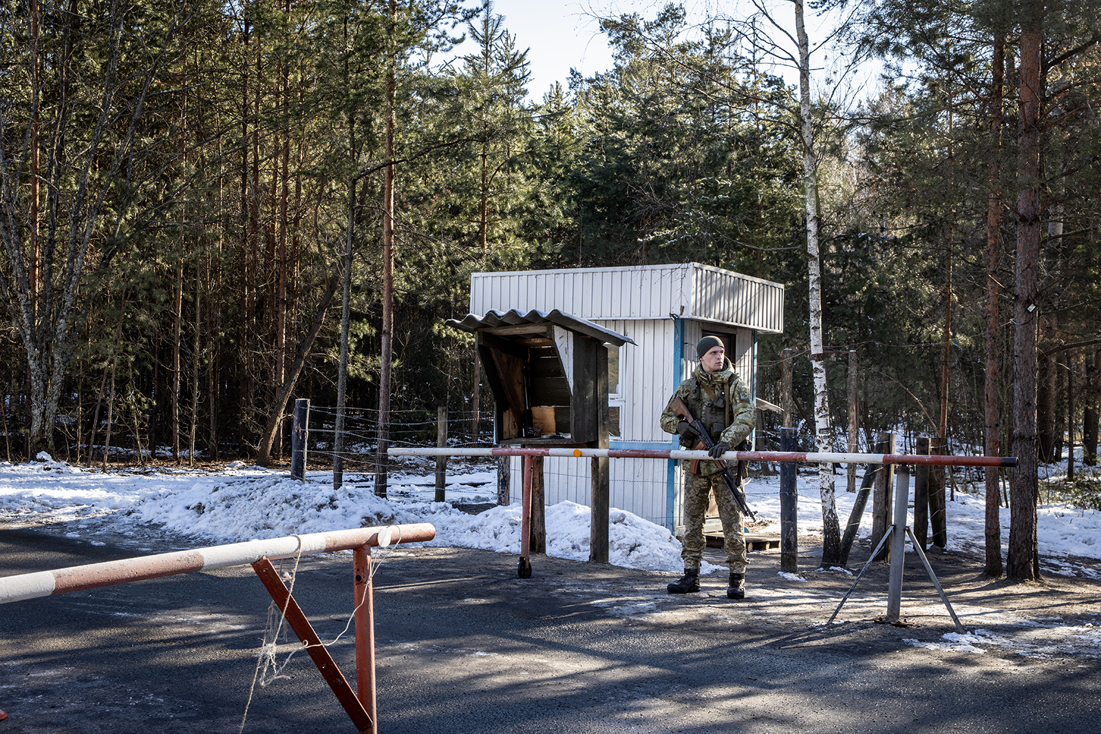 A Ukrainian state border guard at the border crossing between Ukraine and Belarus on February 13, in Vilcha, Ukraine. 