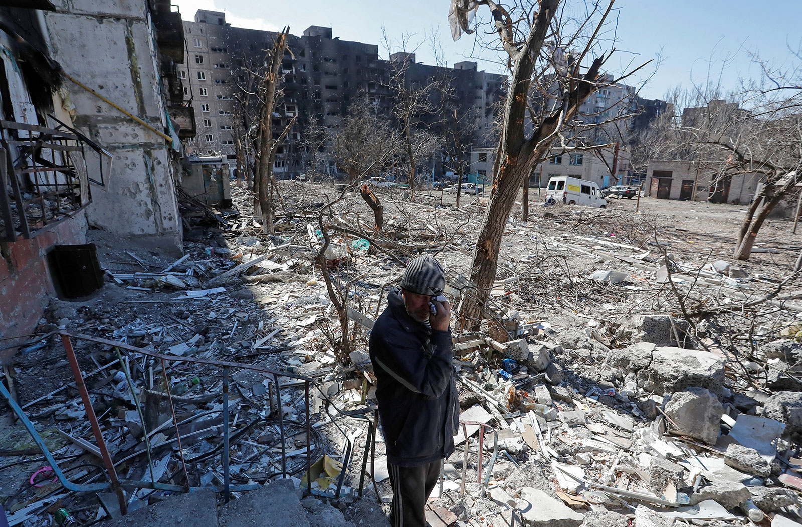 A local resident reacts while standing in the courtyard of an apartment building destroyed in Mariupol on March 28. 