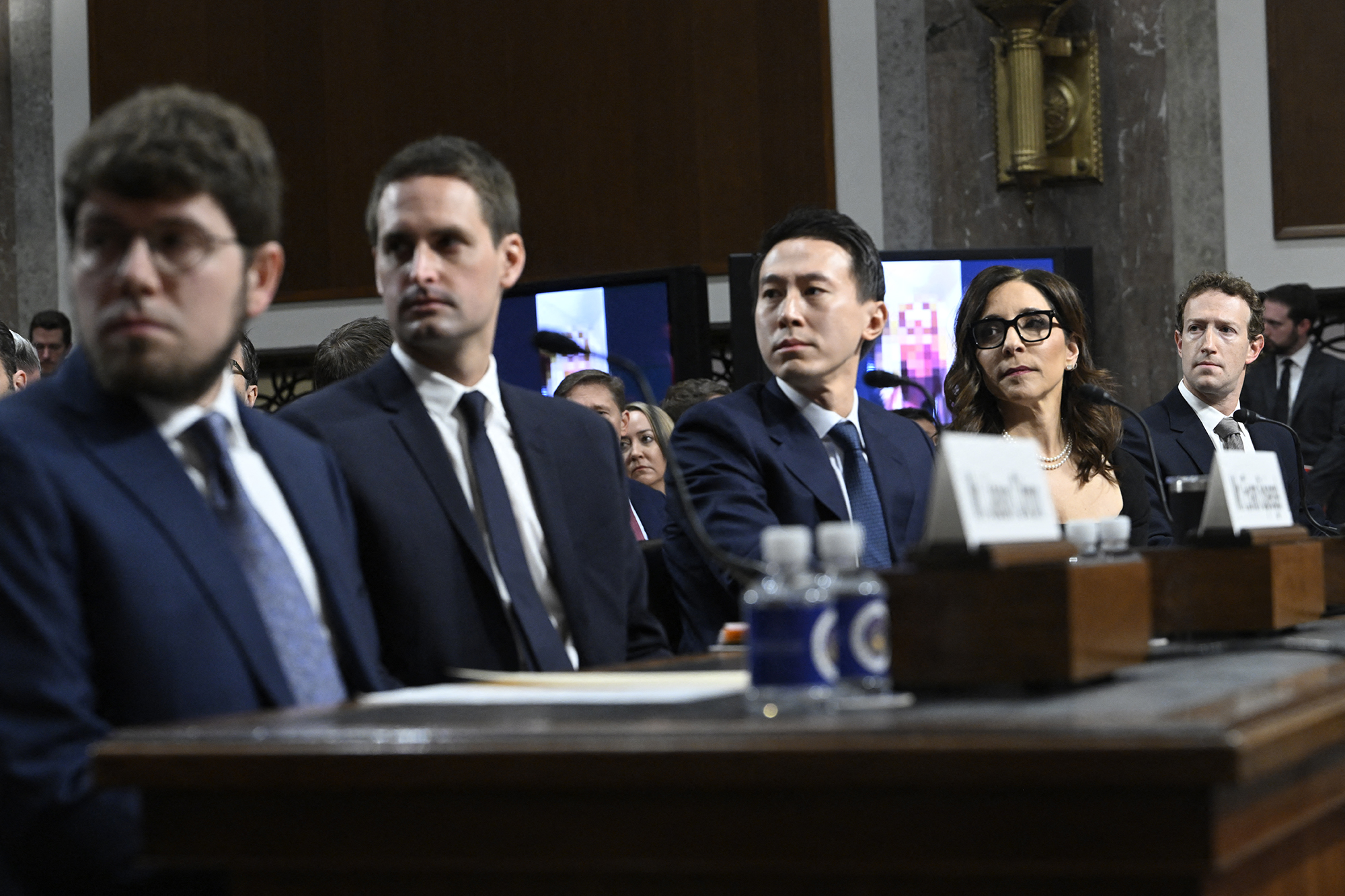 (L-R) Jason Citron, CEO of Discord; Evan Spiegel, CEO of Snap; Shou Zi Chew, CEO of TikTok; Linda Yaccarino, CEO of X; and Mark Zuckerberg, CEO of Meta, watch a video of victims before testifying at the US Senate Judiciary Committee hearing, "Big Tech and the Online Child Sexual Exploitation Crisis," in Washington, DC, today.