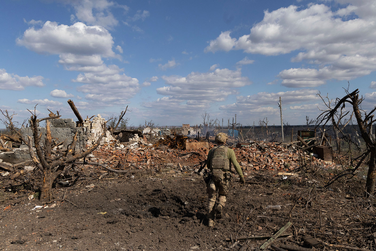 A Ukrainian assault unit commander runs to his position at the frontline in Andriivka, Ukraine, on September 16.